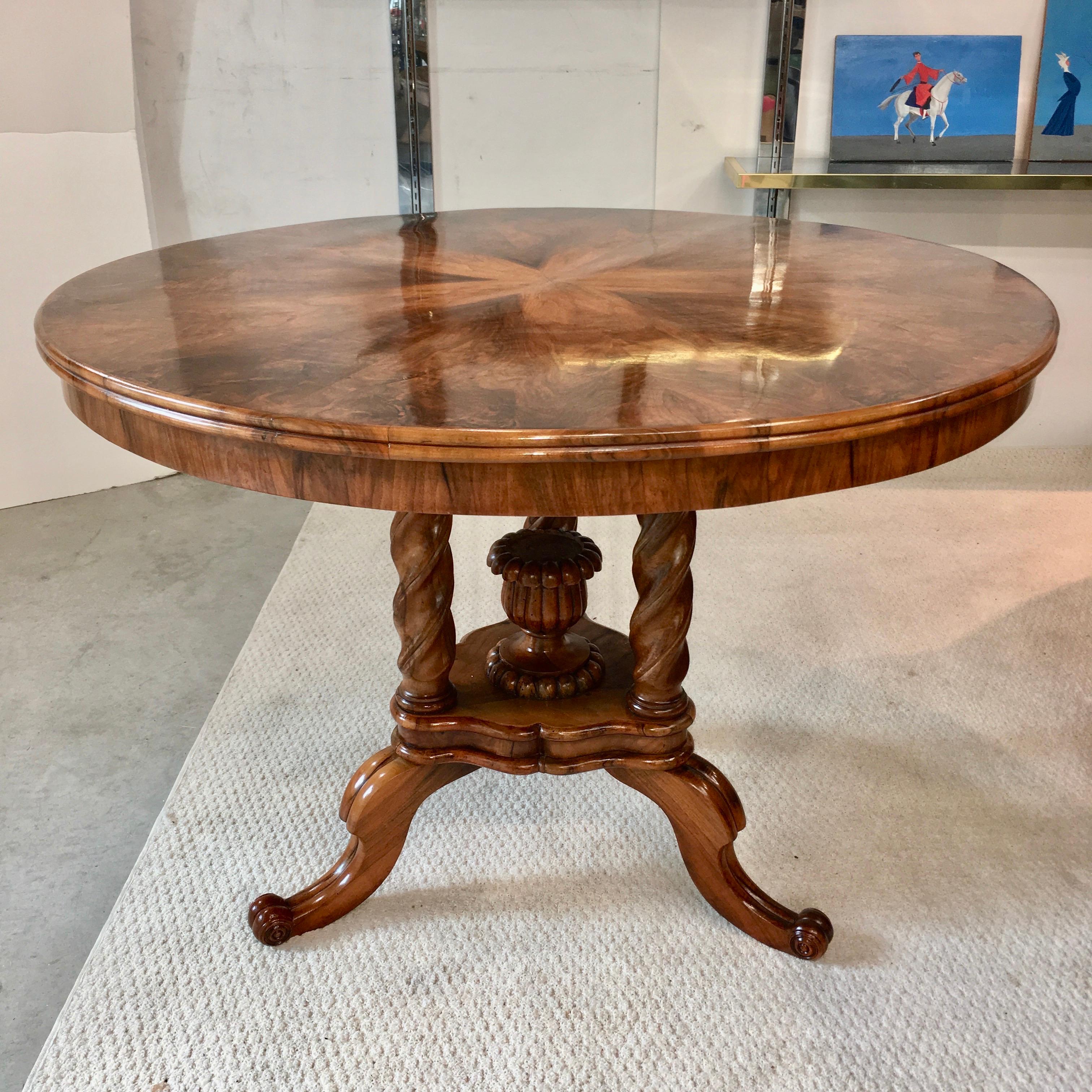 Biedermeier pie figured walnut veneer center table with reed moulded edge on twist turned legs on a moulded plinth base with fluted vase finial on scrolled legs. Beautifully restored. Ready to place.
