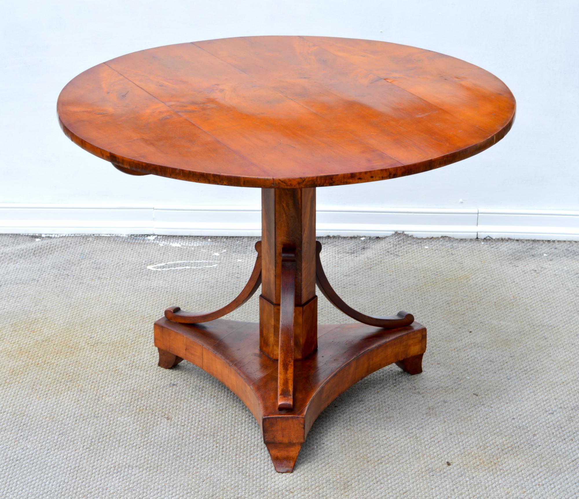 A glorious Biedermeier centre table of cherry, circa 1830. The tilting three board top is supported by a panelled hexagonal stem met with carved stemmed supports. All is floating on perfectly designed spade feet.
A wonderful statement piece for the