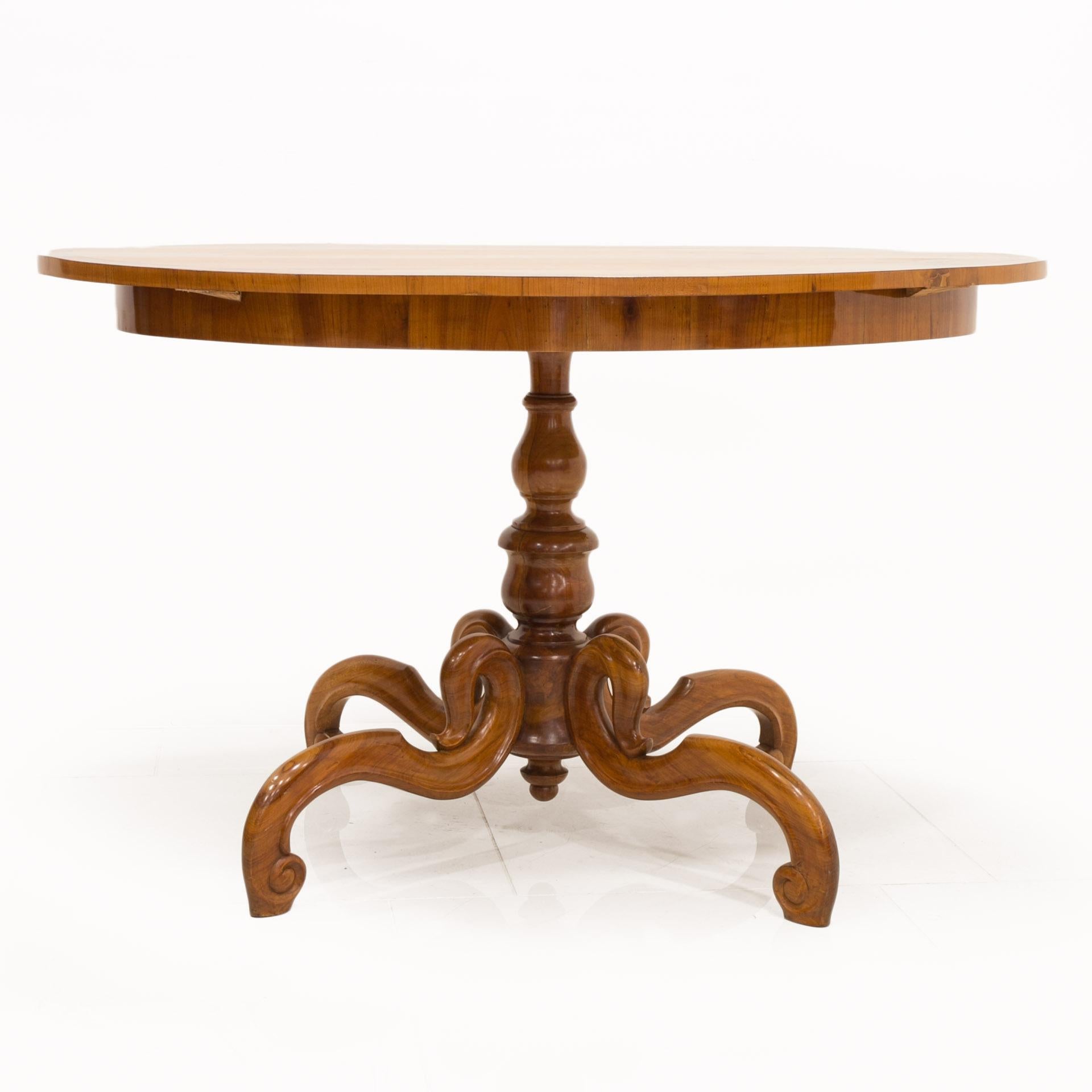 This beautiful, unique, original, oval Biedermeier table comes from Austria from 1st half of the 19th century. The leg is made of cherry wood. Surface was finished with shellac polish, applied by hand with a tampon, which, in addition to an