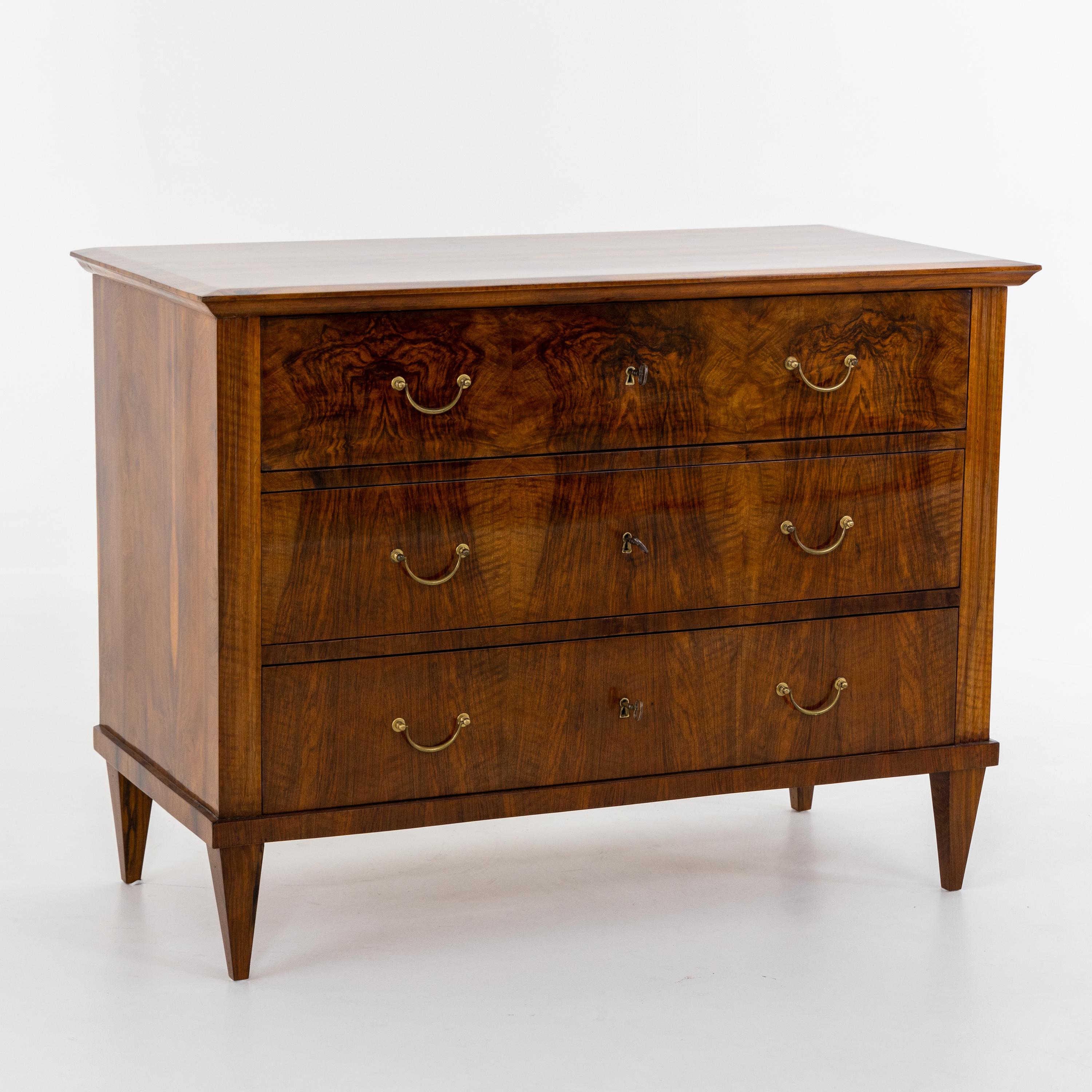 Biedermeier chest of drawers with three drawers on square tapered legs in walnut veneer. The commode was professionally restored and hand polished.