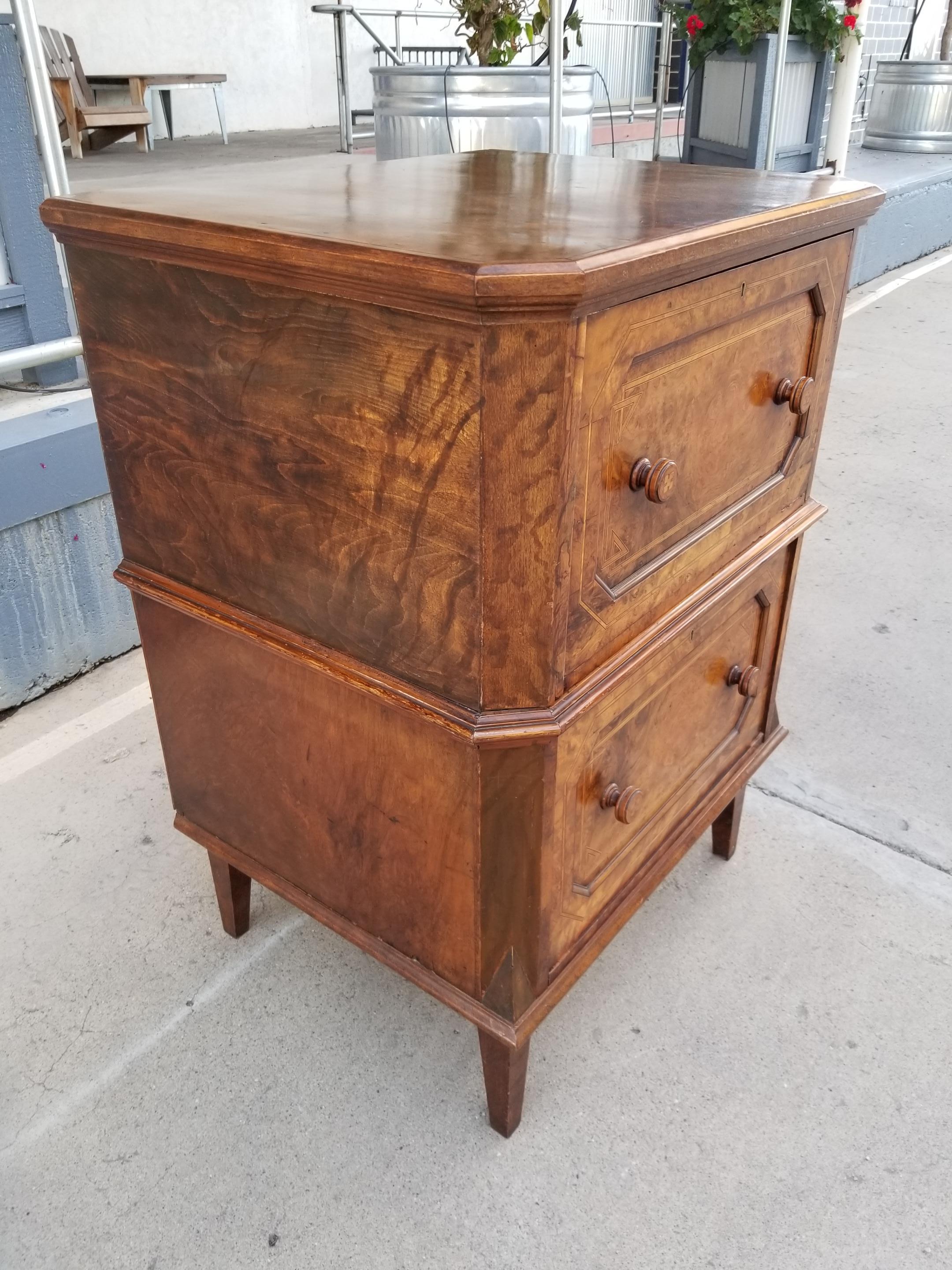 Unusual 19th century burl wood dresser or storage cabinet with inlay marquetry details. Two deep drawers with handmade dovetail. Original pulls also with marquetry detail. Piece has been restored / modified over its lifetime. Back side has been