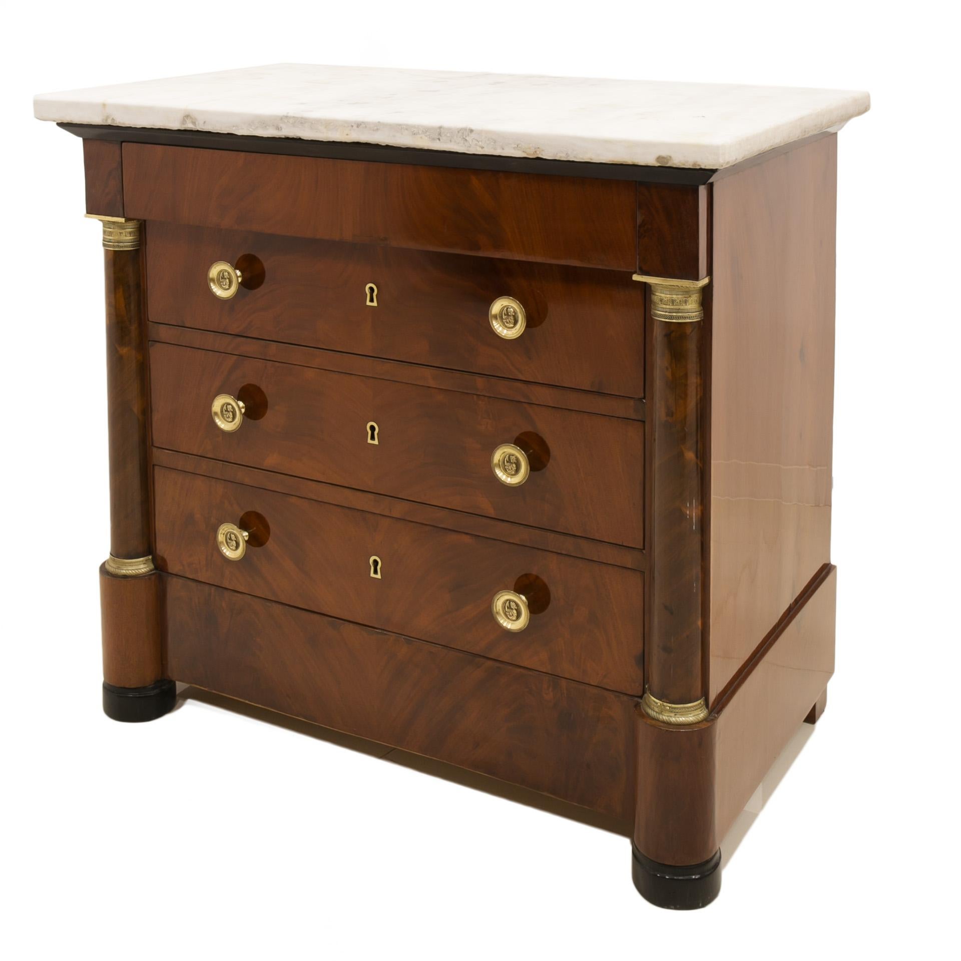 Biedermeier style chest of drawers from 19th century, circa 1830s. This piece of furniture comes from France. It was made of softwood and veneered with beautiful mahogany pyramid veneer. It features 3 drawers lockable with keys and 1 smaller one in