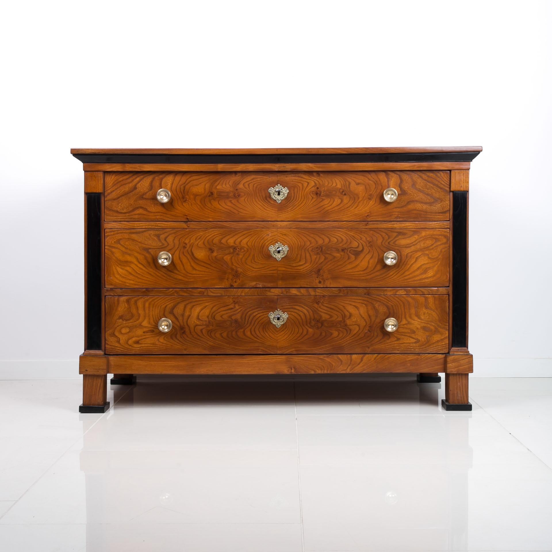 Biedermeier chest of drawers from first half of 19th century. This piece of furniture comes from France. It is veneered with beautiful elm wood veneer. It has undergone a careful renovation process in our workshop, during which the structure was
