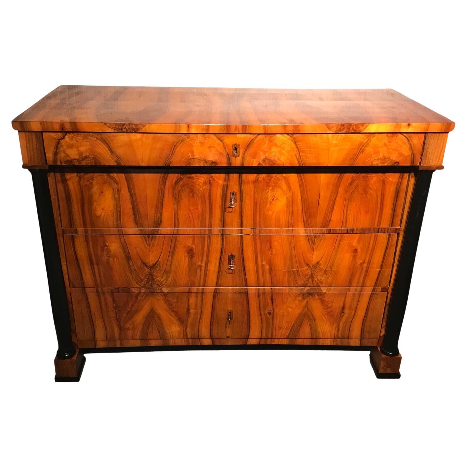 Exquisite Biedermeier Walnut Dresser from 1820, Southern Germany. This remarkable Biedermeier chest of drawers, dating back to 1820 and originating from Southern Germany, is a true testament to craftsmanship and timeless beauty. Standing on four
