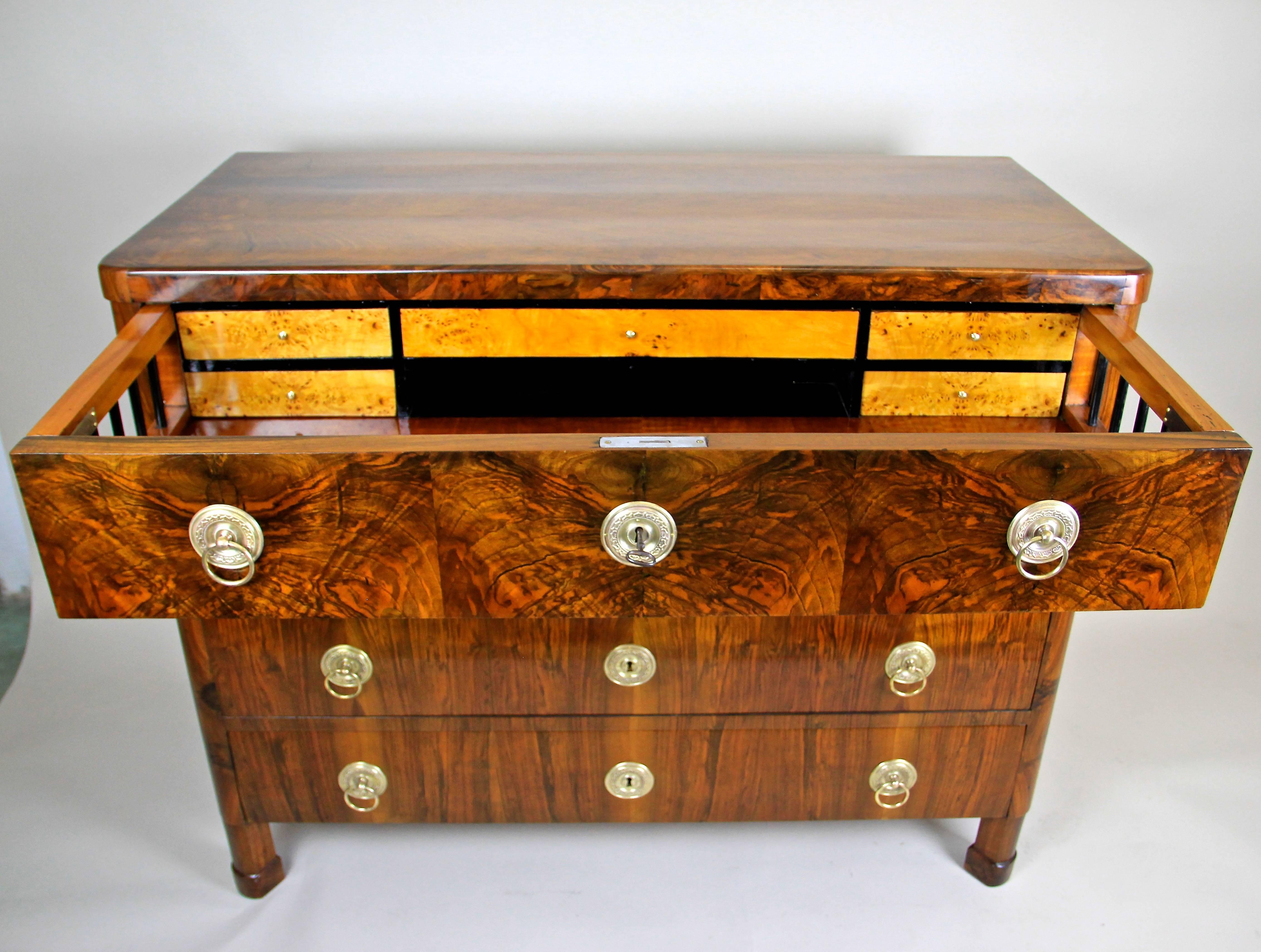 Outstanding Austrian Biedermeier chest of drawers/ writing commode in fine nut wood from circa 1830. Impressing with an absolute fantastic grain, this completely restored four drawer commode is a real transformer. Three big drawers provide a lot of