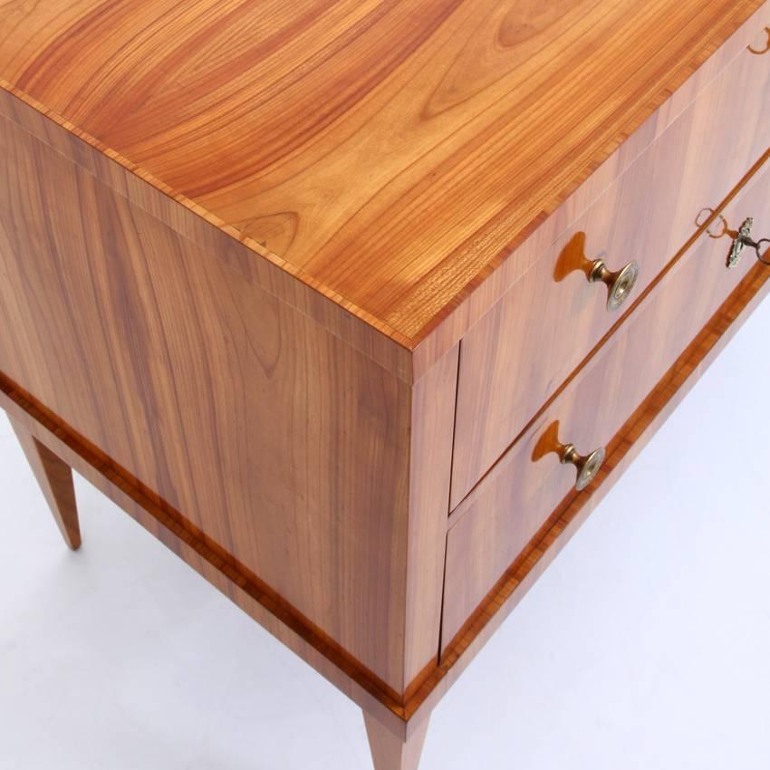 Two-drawer Biedermeier chest of drawers standing on tapered legs. Very beautiful cherrywood veneer, especially on top.
