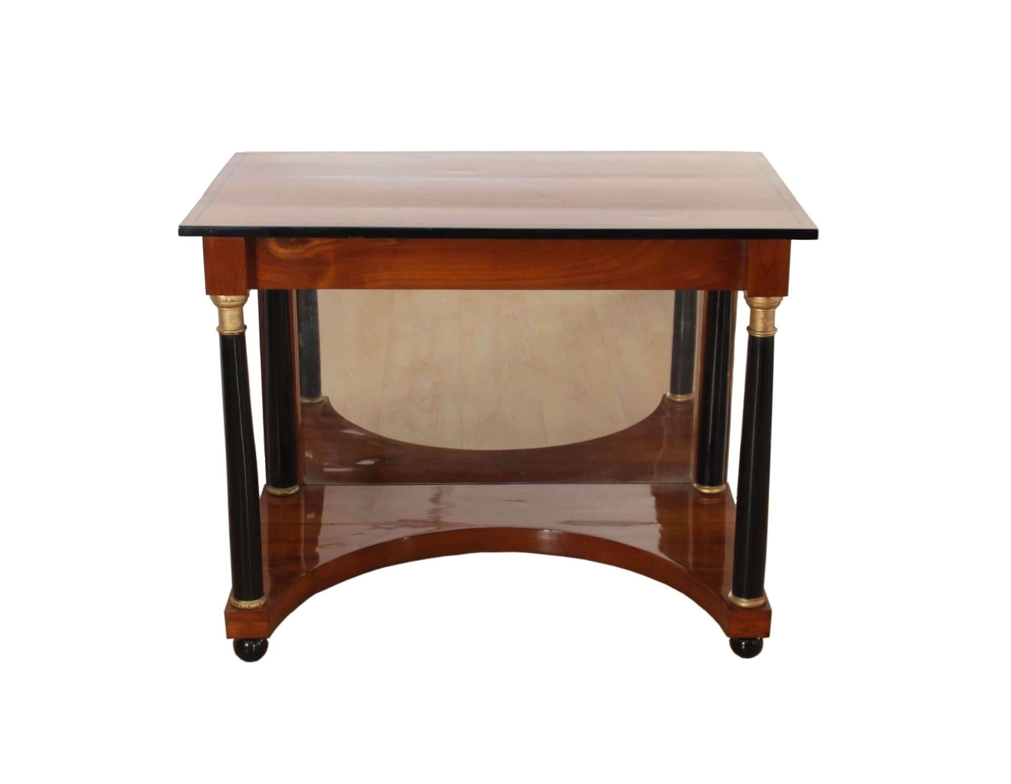 Elegant neoclassical Biedermeier Console Table from South Germany about 1820.

Concave base veneered in cherrywood in with mirror glass (replaced) in the back. The plate is cherry solid wood with ebonized parts and an ink trim. Hand-polished with