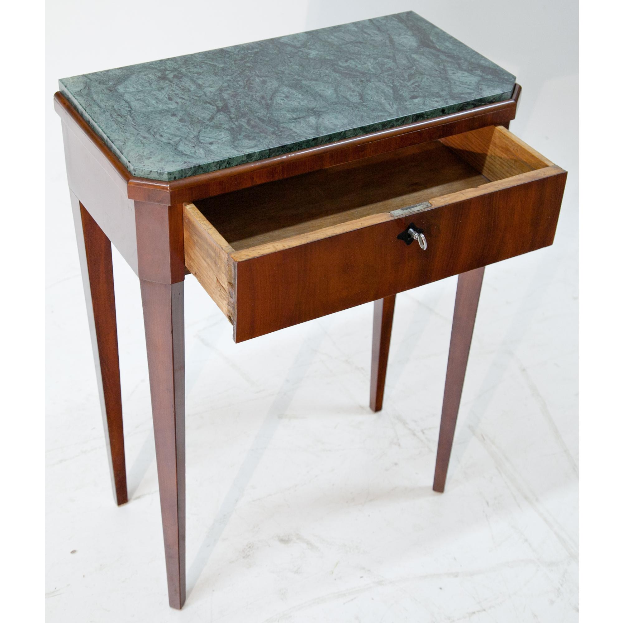 Small tall-legged console table with one drawer and ebonized escutcheon. The green stone top was added later.
