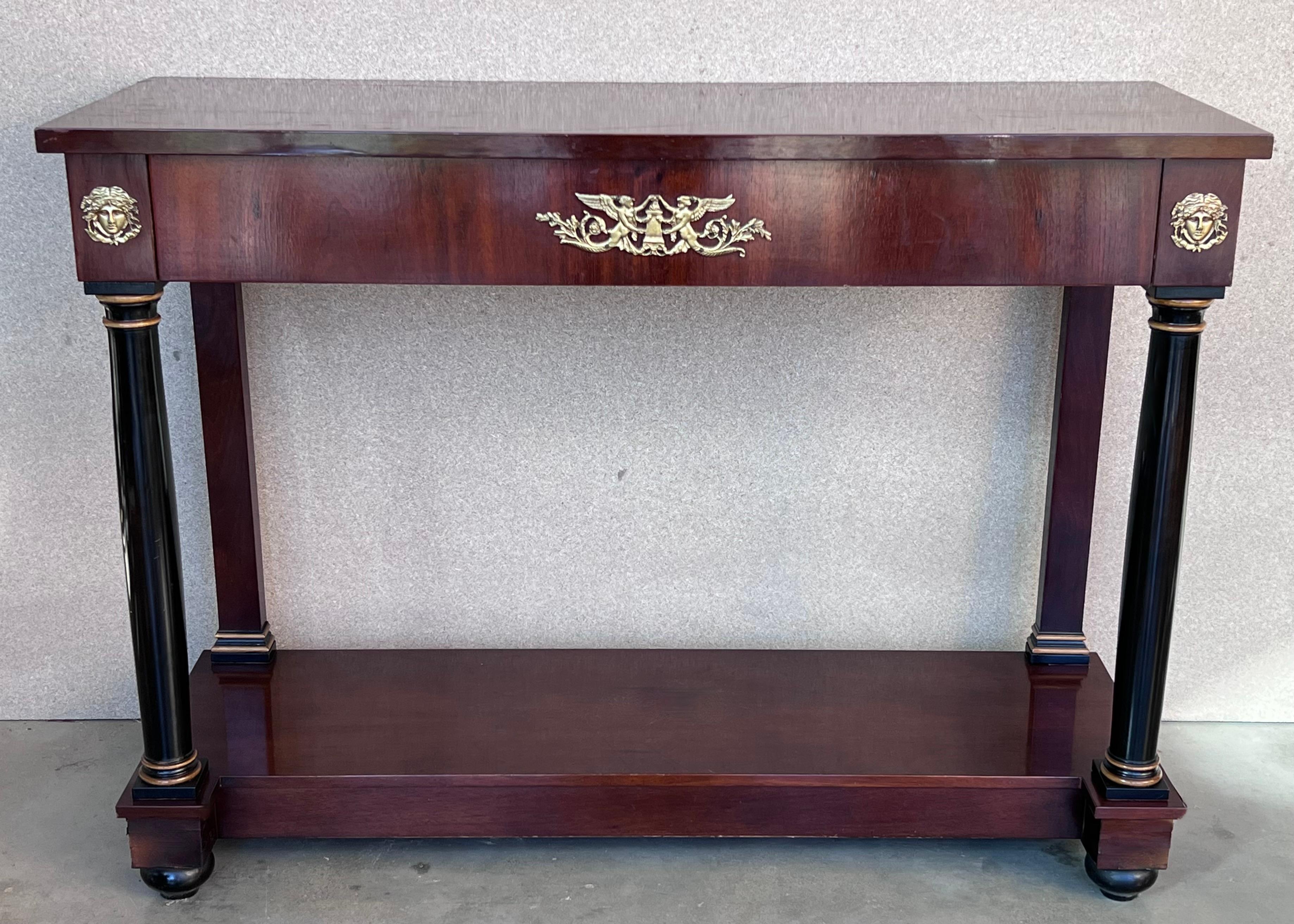 Handsome 19th century Empire style console in walnut adorned with ebonized column legs and rectangular base, Vienna, circa 1840.