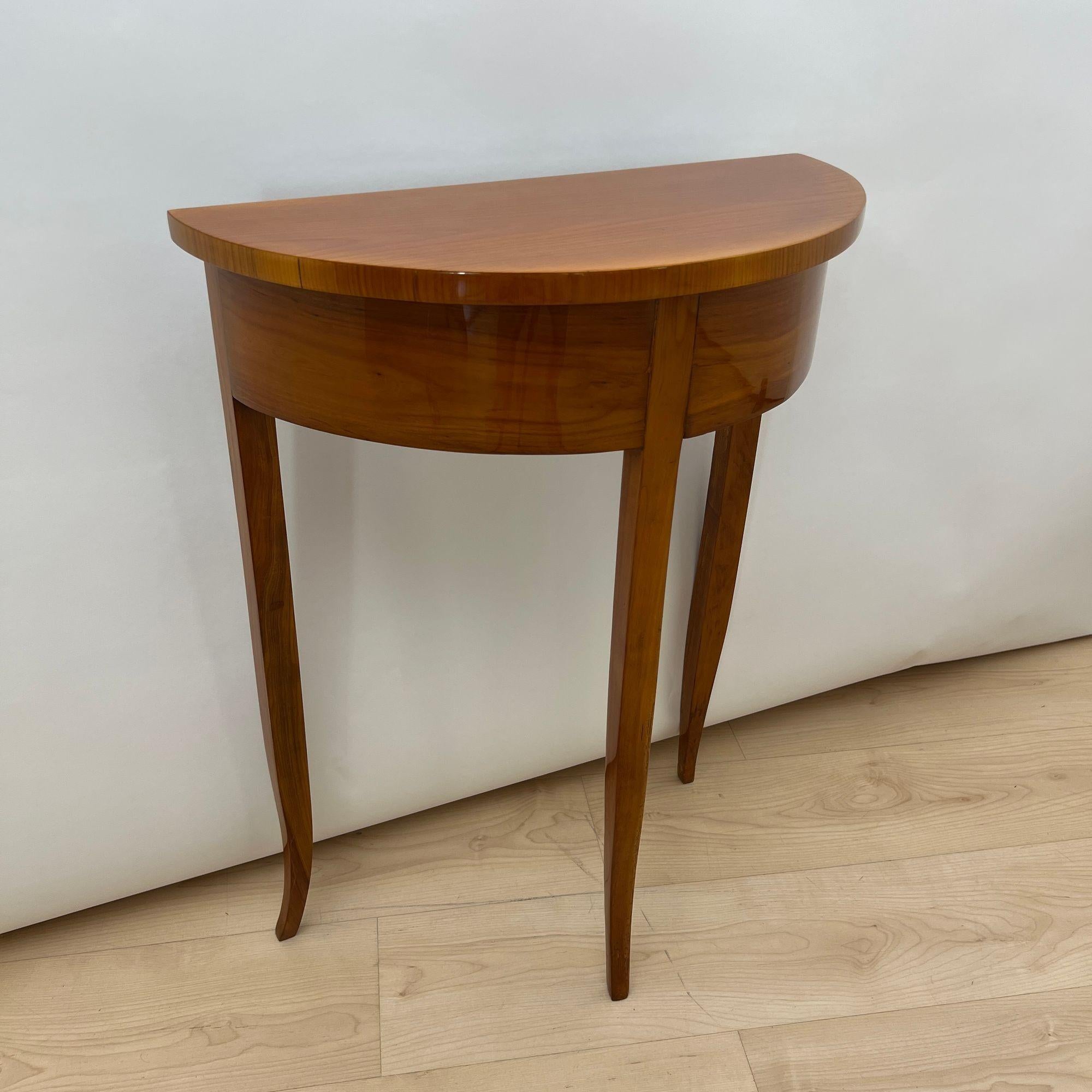 Small Biedermeier Demi-lune console table from South Germany, circa 1820.
Cherry veneered (apron) and solid (legs and top). Restored condition, hand-polished with shellac.
Dimensions:
* H 76 cm / 29.9 in
* W 57.5 cm / 22.6 in
* D 28 cm / 11 in