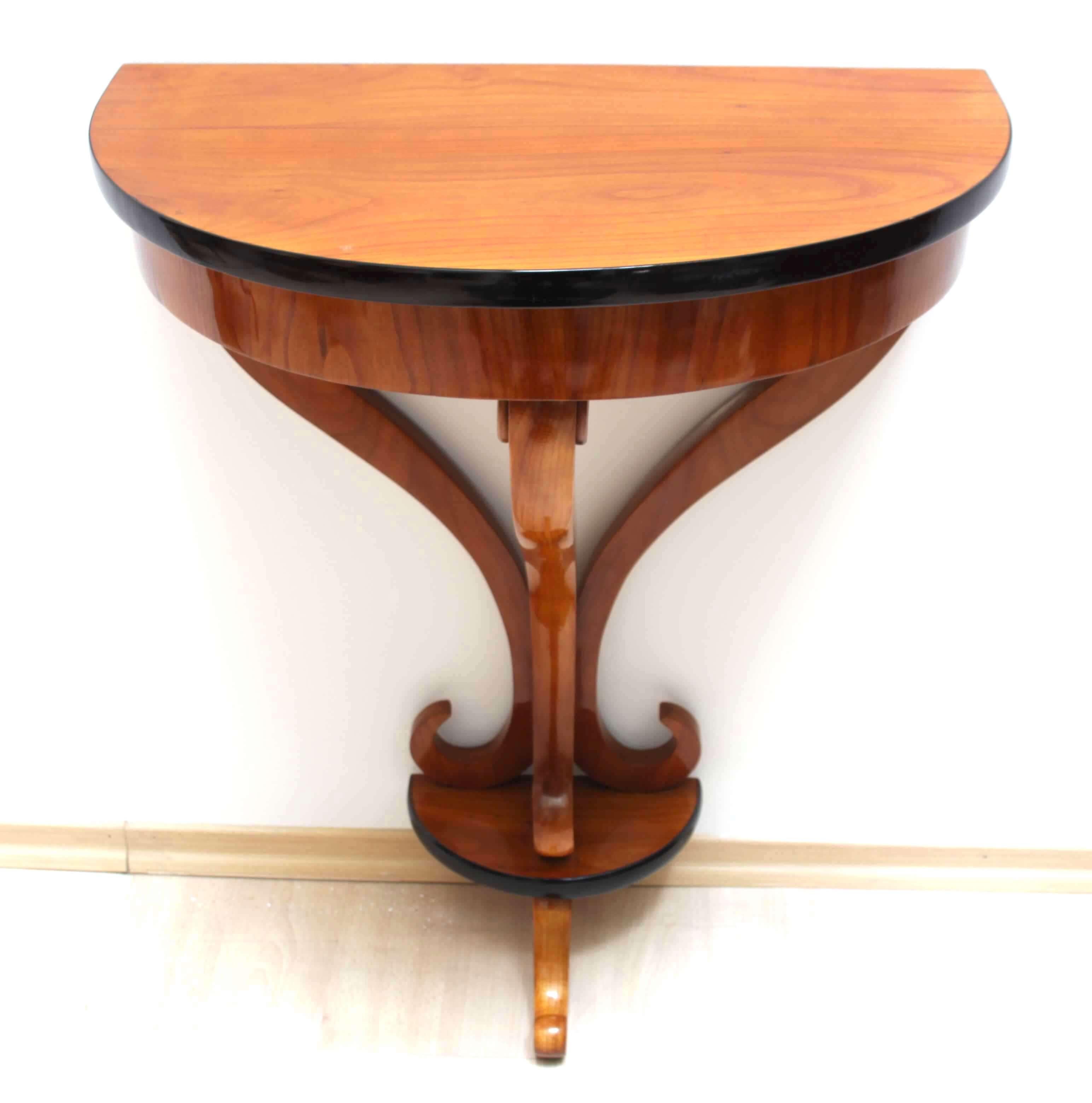 Beautiful neoclassical Biedermeier demilune (Half Moon) console table from South Germany, circa 1830.

Beautiful bright and friendly cherry veneer and solid wood, hand polished with shellac (french polished) and ebonized (black polished) edges.
