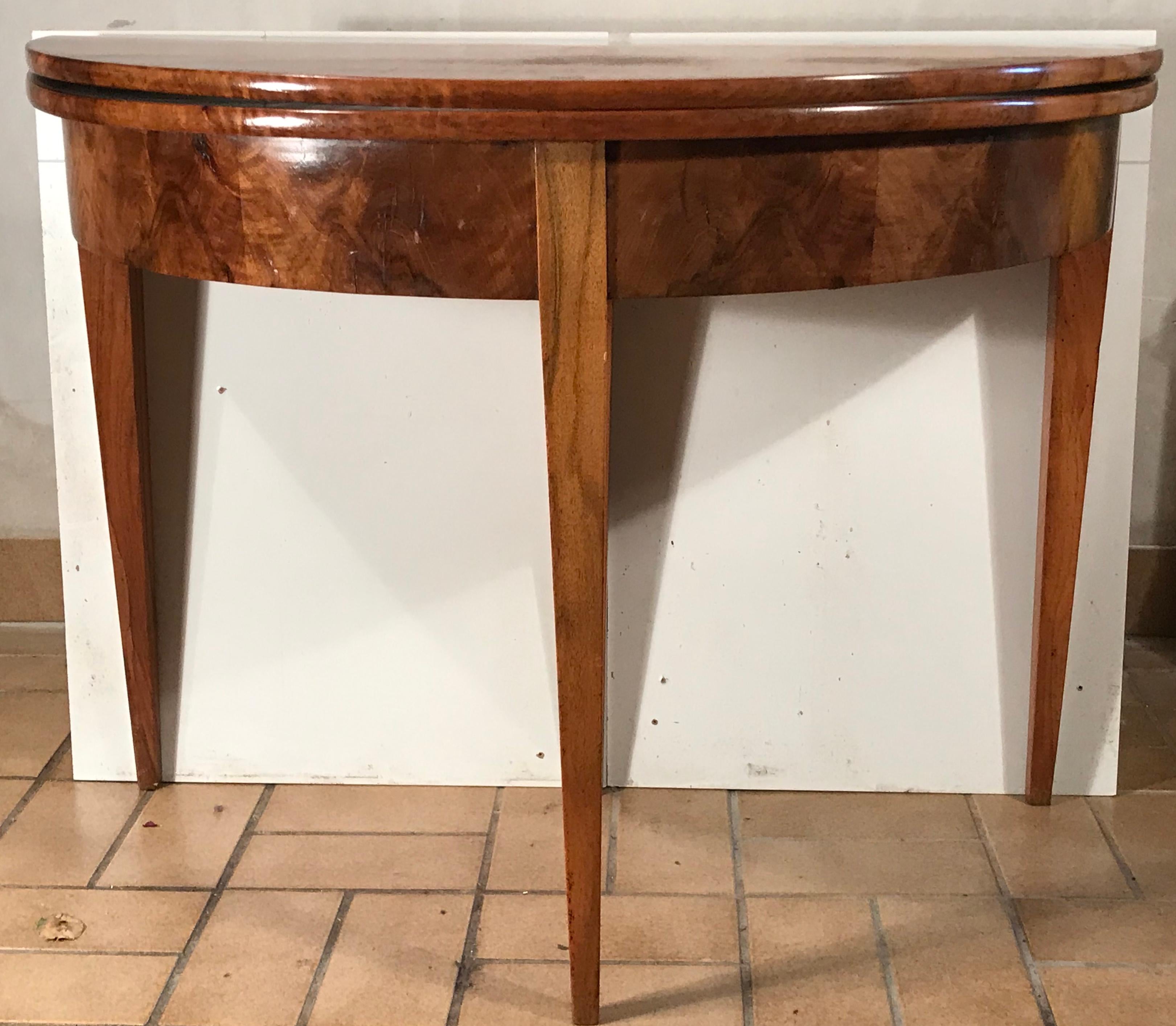 Original Biedermeier demilune table, South German 1820, walnut veneer. The table is in good original condition.
It could be used as a console table in an entry way or a safe spacing dining table in a small apartment with the option to use it folded