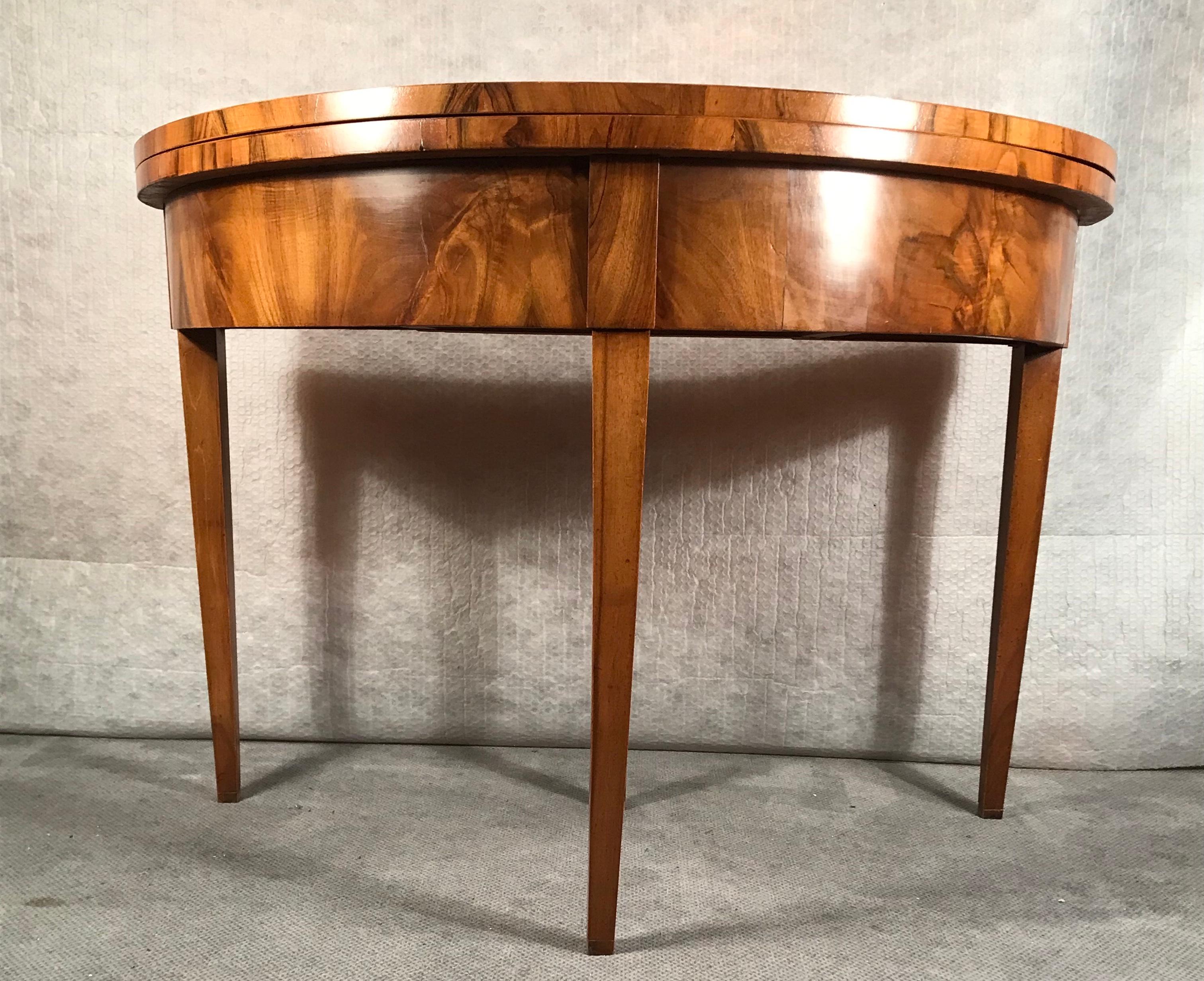 Biedermeier demilune table, South German, 1820. This beautiful table is decorated with a vivid walnut veneer. It is in very good condition and has a nice patina.
The demilune table ships from Germany and includes shipping costs to Boston.