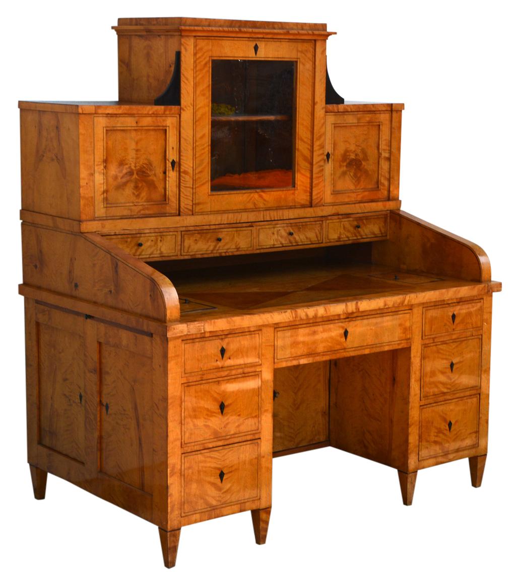 Biedermeier desk, northern Germany, 1830s. Made of birch.

Conical square feet, writing boxes on both sides, each with three drawers with double thread inlays and diamond-shaped key inlays, a further drawer in the centre and two doors in the rear