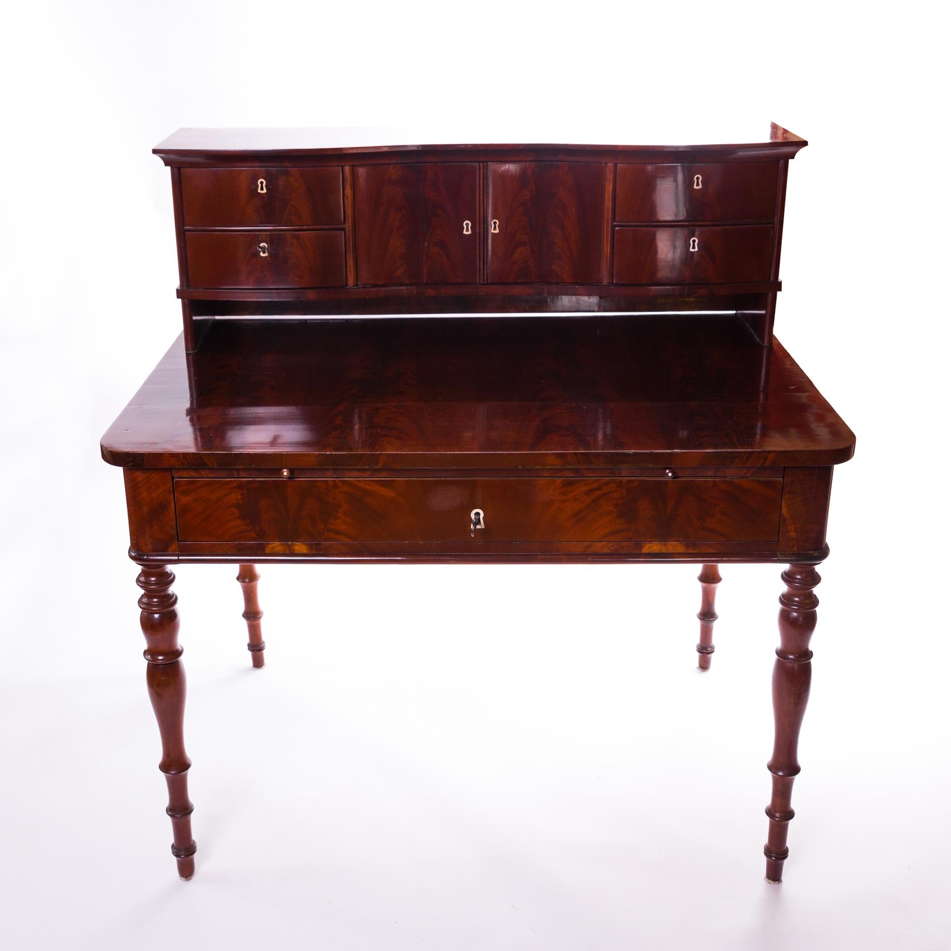Polish secretary made of pyramid mahogany, polished. Made circa 1840 in the Biedermeier style. Beautiful proportions, expensive veneer, moderate ornamentation. Native bourgeois origin.

The main decoration of the desk is a long, central drawer