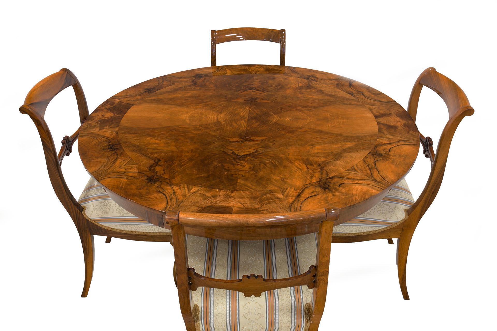 This beautiful dining room set is made of walnut wood and come from Germany from around first half of the 19th century. The round shape of the table allows comfortable and easy use. Chairs are after complete renovation. The surface of table and