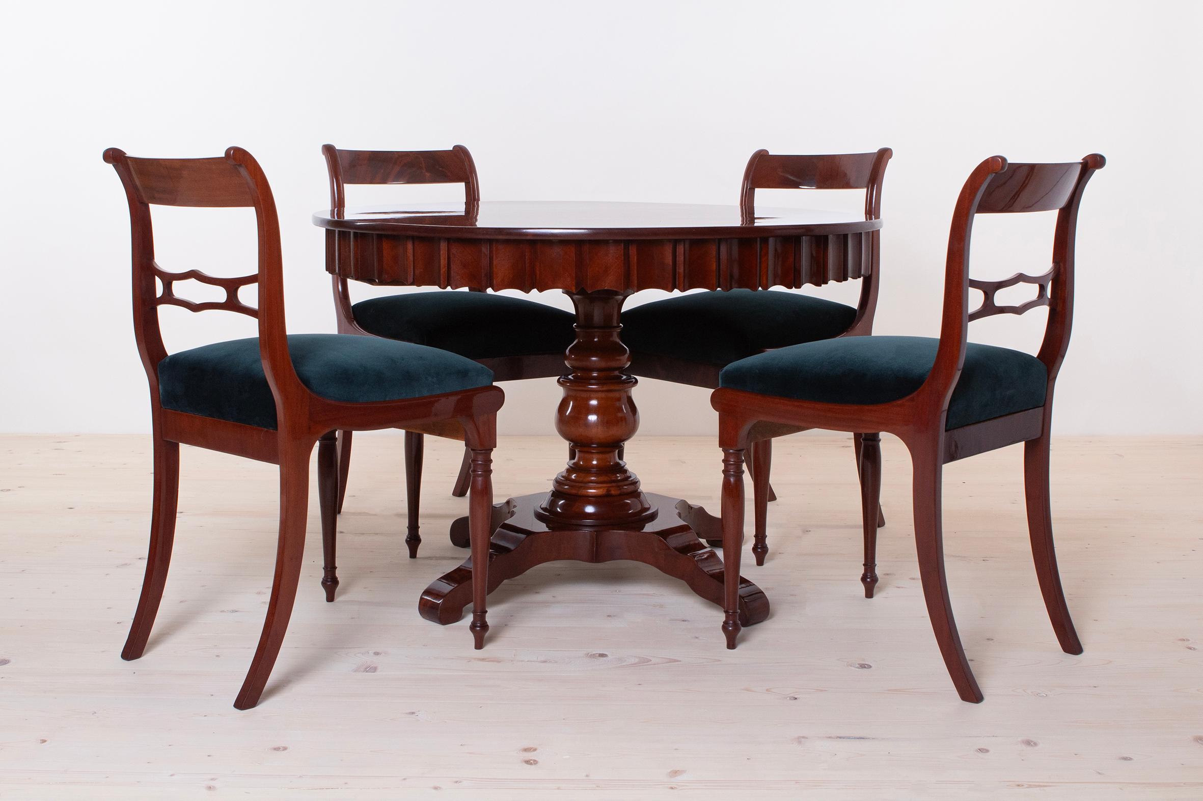 This beautiful dining set was made in Austria in 19th Century. It consists of 4 chairs and round table. It is made of mahogany wood and the chairs backrests are veneered with mahogany as well. The whole set was carefully restored. All wooden
