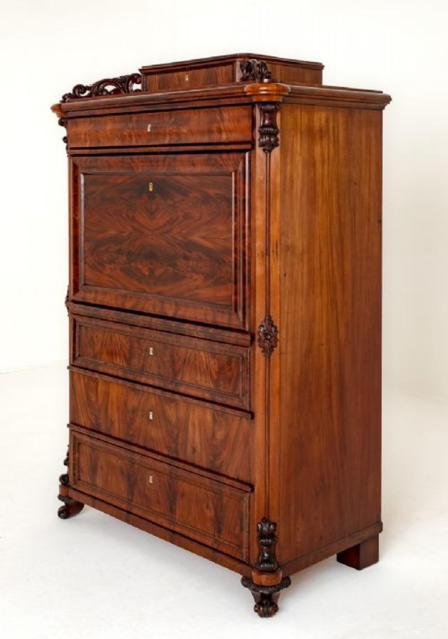 Biedermeier Mahogany Escritoire.
This Escritoire Features 5 Drawers and a Pull Down Writing Slope. Circa 1860
The Drawers and Fall Having Wonderful Matched Flame Mahogany Veneers.
The Piece Standing Upon Small Carved and Shaped Feet.
The Corners
