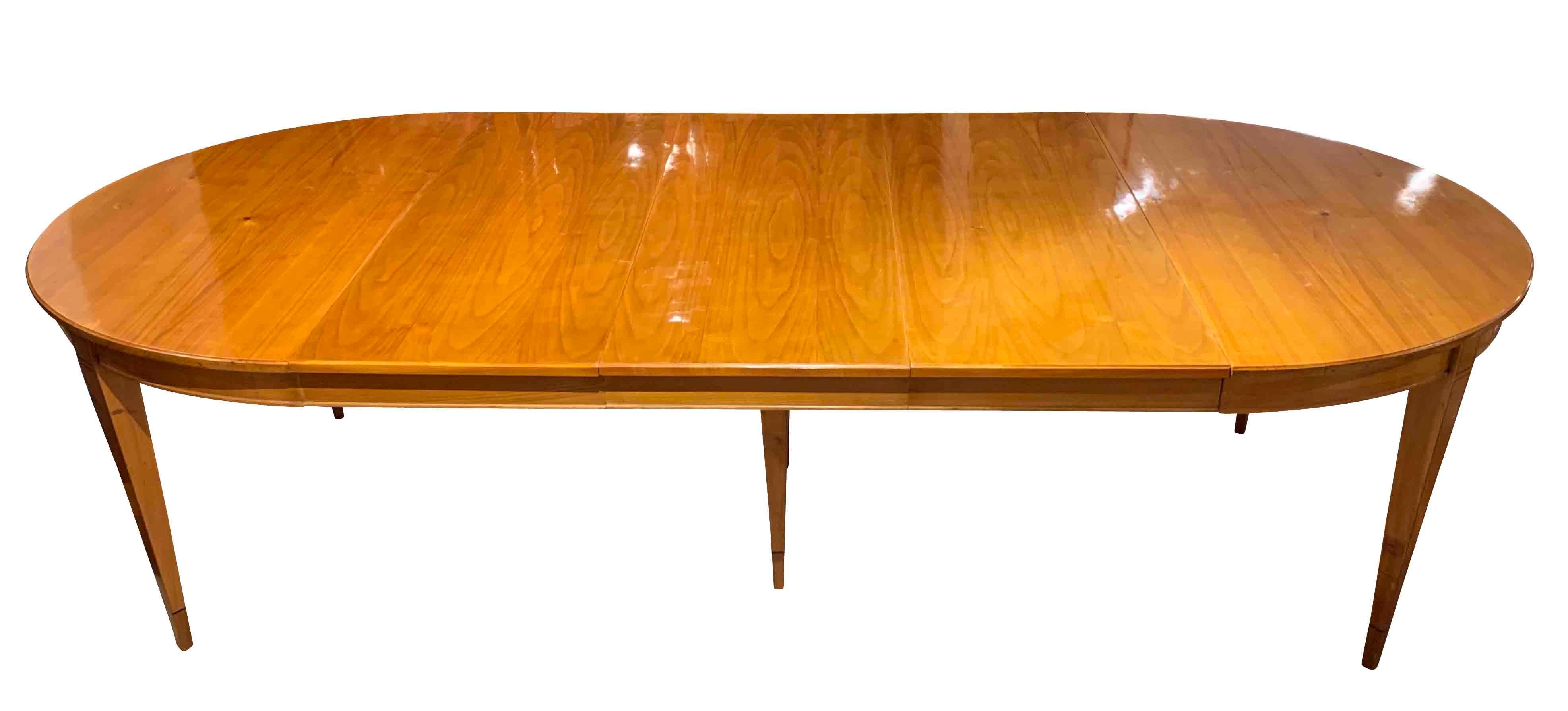 Beautiful Biedermeier expandable / extending / pull-out dining room table

Closed oval form with three inlay plates a 48.5 cm / 19.1 in (supplemented)
Conical square-pointed legs with ebony inlay band.
Wood: Cherry solid (Plate and legs) and