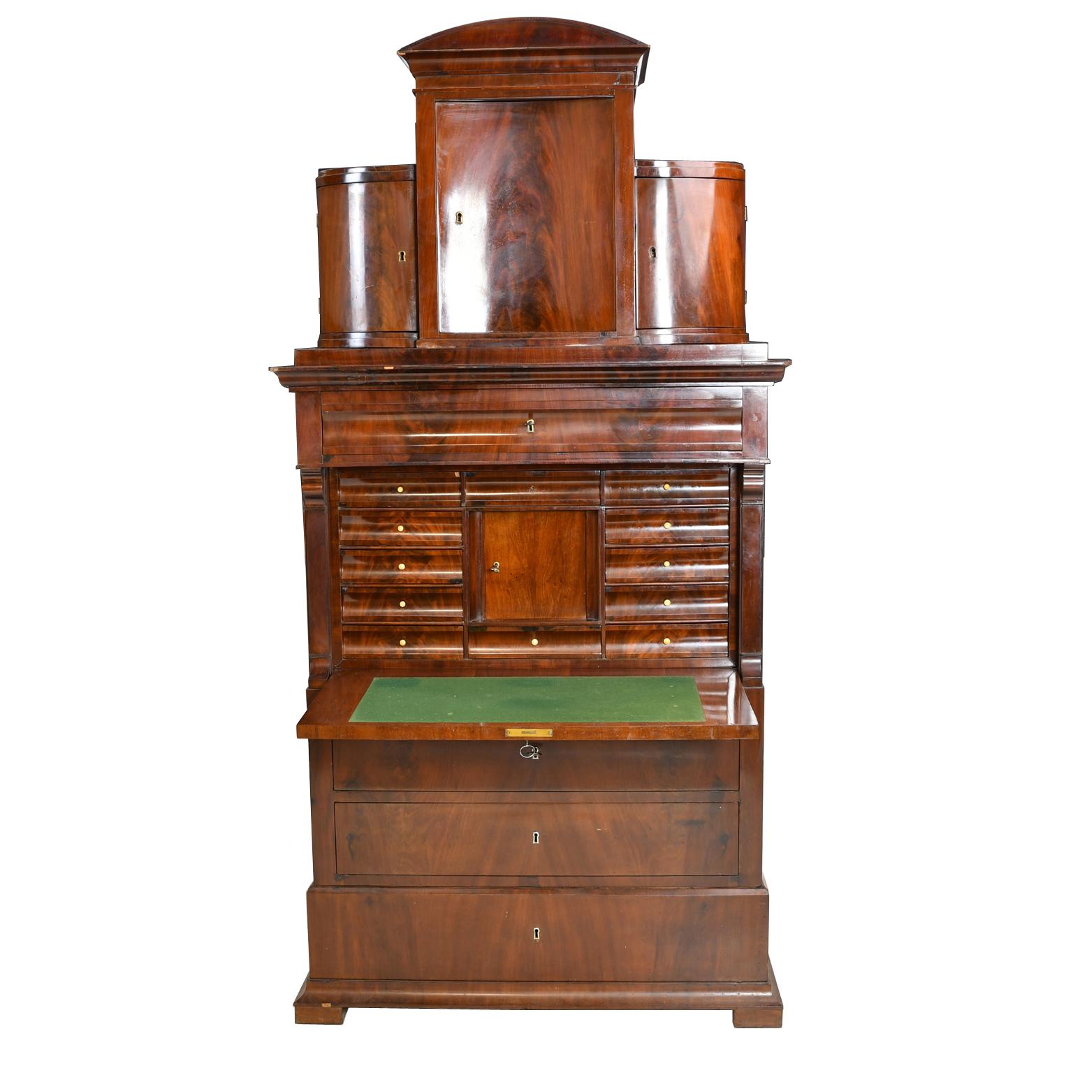 Classic Northern Europe Biedermeier fall front secretary over a flight of drawers with original pediment top.
This Danish secretary fabricated in Copenhagen, c. 1820 has 4 full drawers a fall front writing surface with ample work space, a flight of
