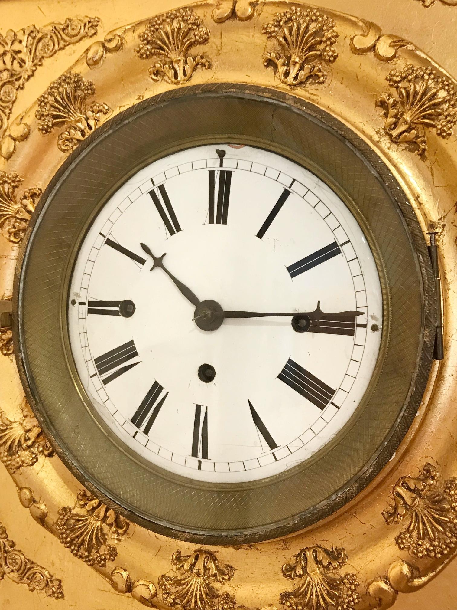 Biedermeier frame clock, circa 1850

Spring Balancer Daily Mechanism, 4/4 hour strike, enamel dial, glazed bezel, ornamented golden frame case, Austria circa 1850, signs of age and wear, no guarantee for function and completeness, 1 pendulum, 1