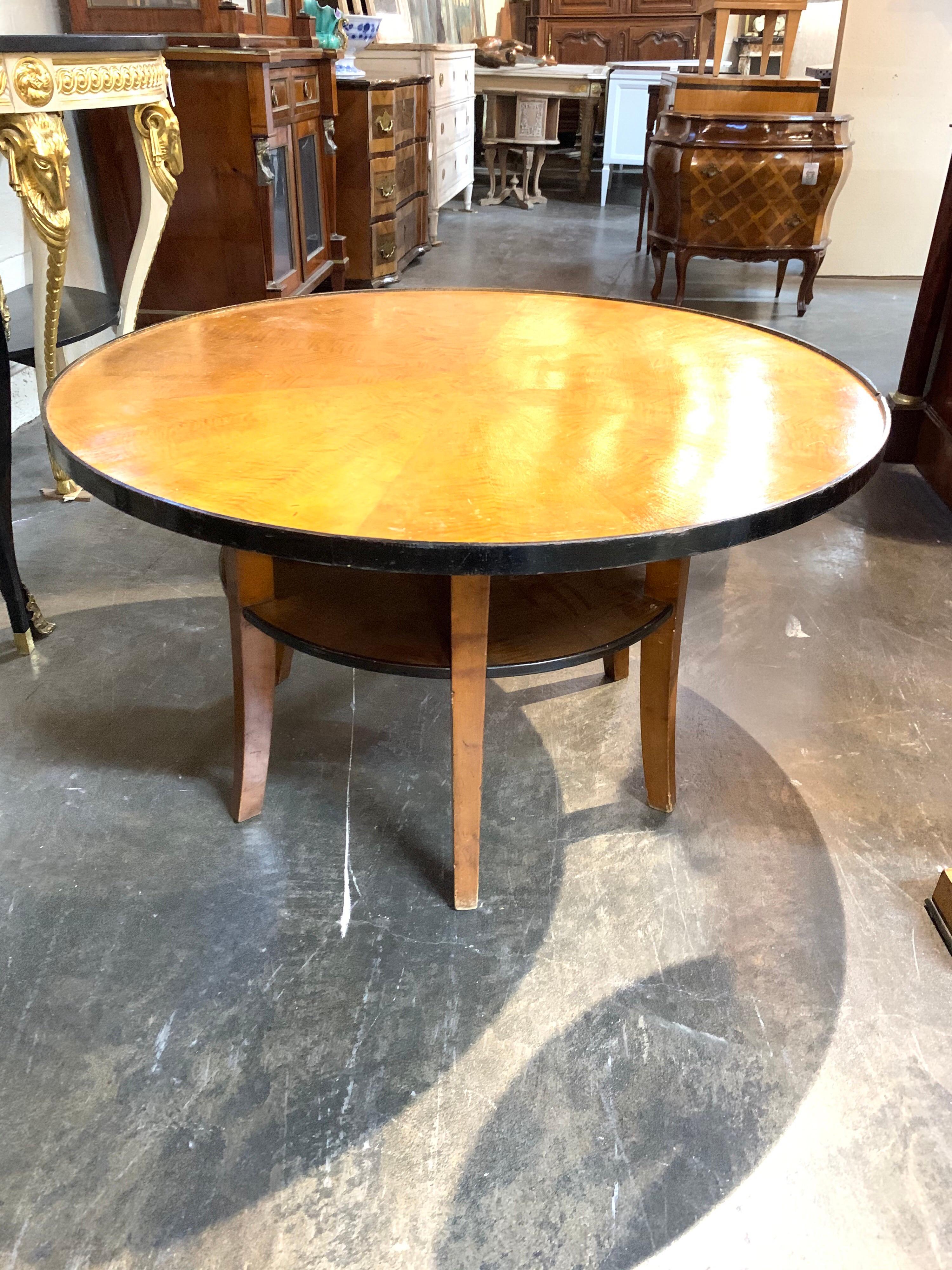 Beautiful midcentury Biedermeier fruitwood ebonized cocktail table with a lower shelf. A very fine table that mixes well with a variety of decors.