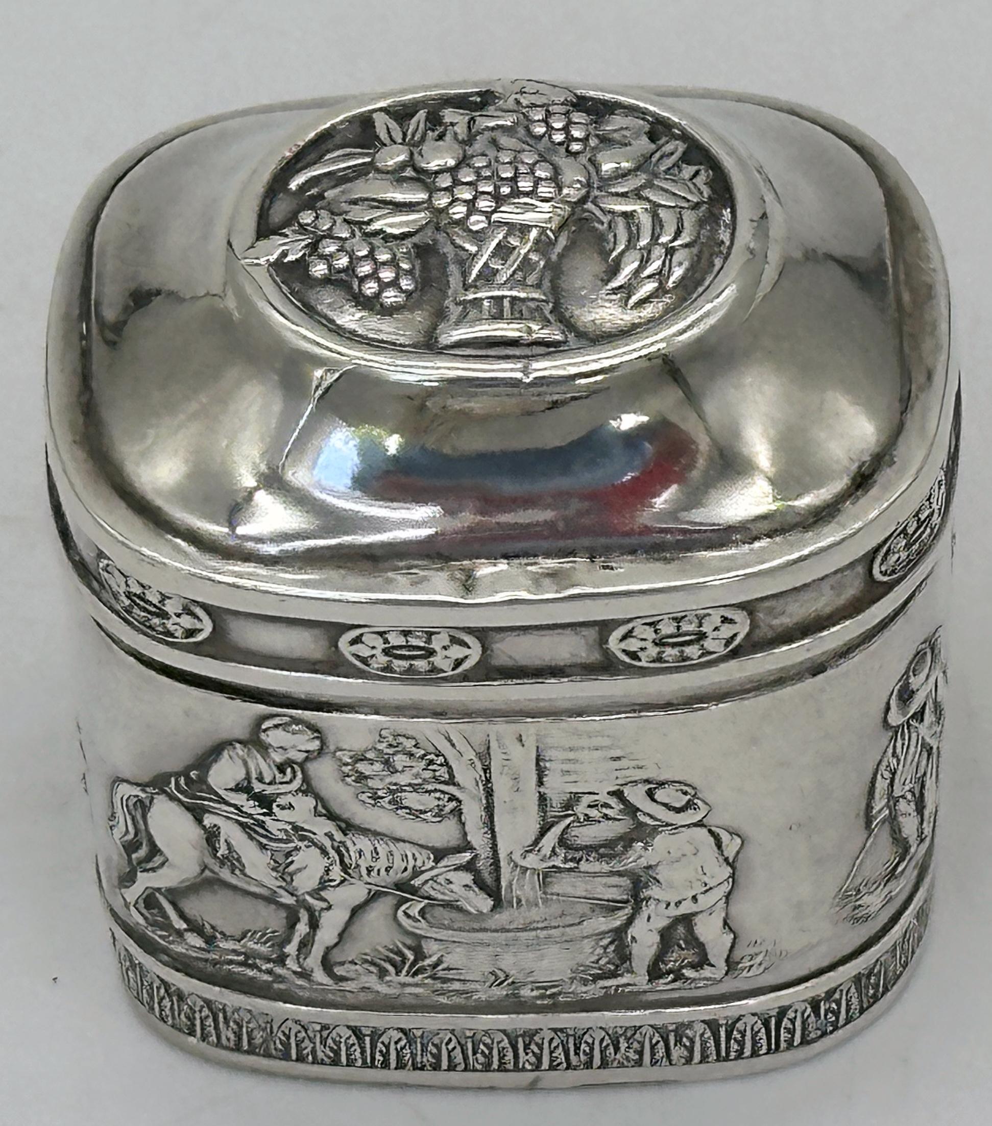 Unusual 19th Century German .800 Silver Snuff Box with Repoussé Rural Scenes and Fruit Basket Lid

A charming and unusually shaped 19th-century German silver snuff box, expertly crafted in repoussé with richly detailed pastoral scenes. Measuring