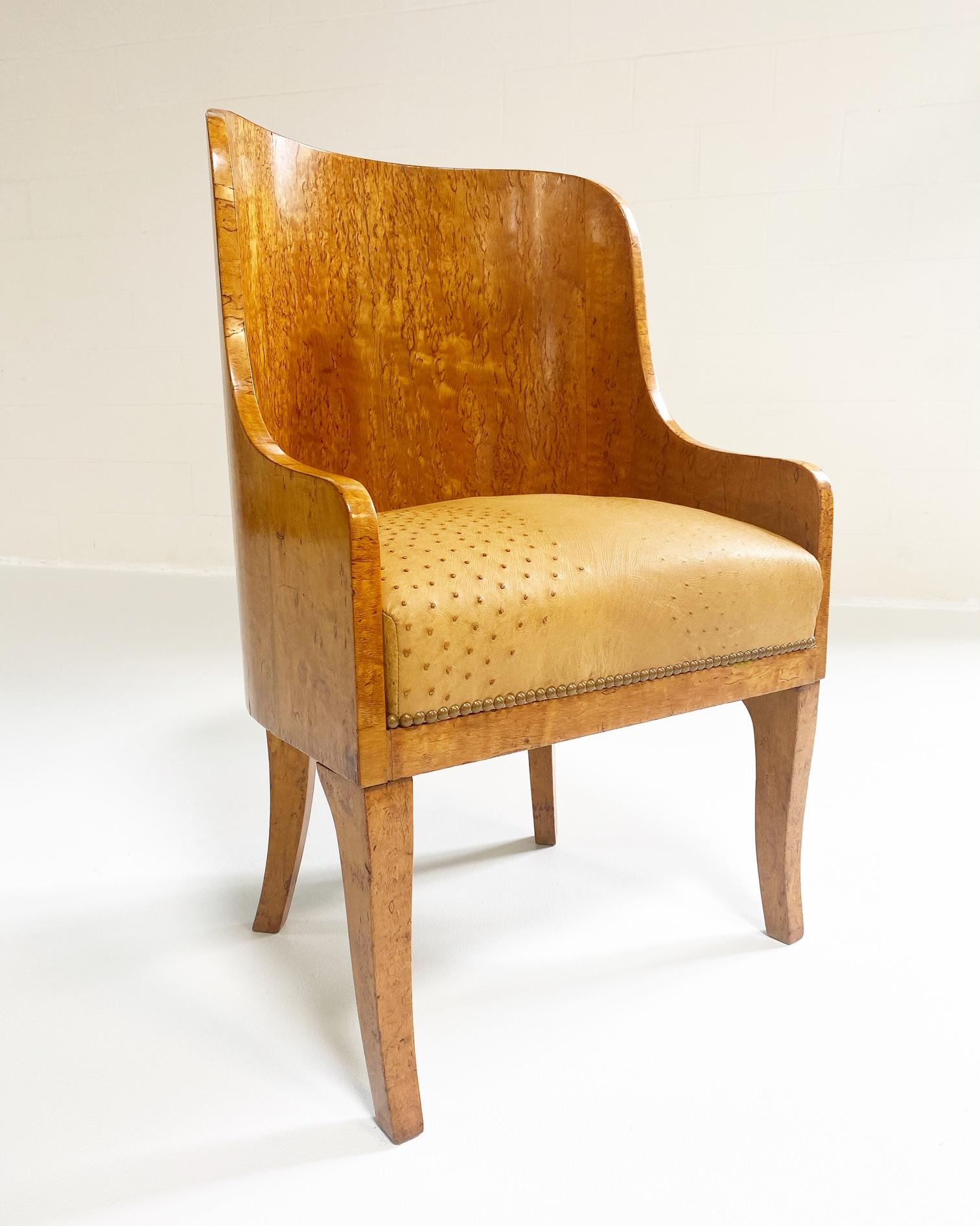 What's cooler? The shape of these chairs or the color. We love the barrel-back forms, the figured backs wrapping around to closed arms, with saber-form legs. And that gnarled birch in the loveliest golden hue. Expertly restored with an ostrich
