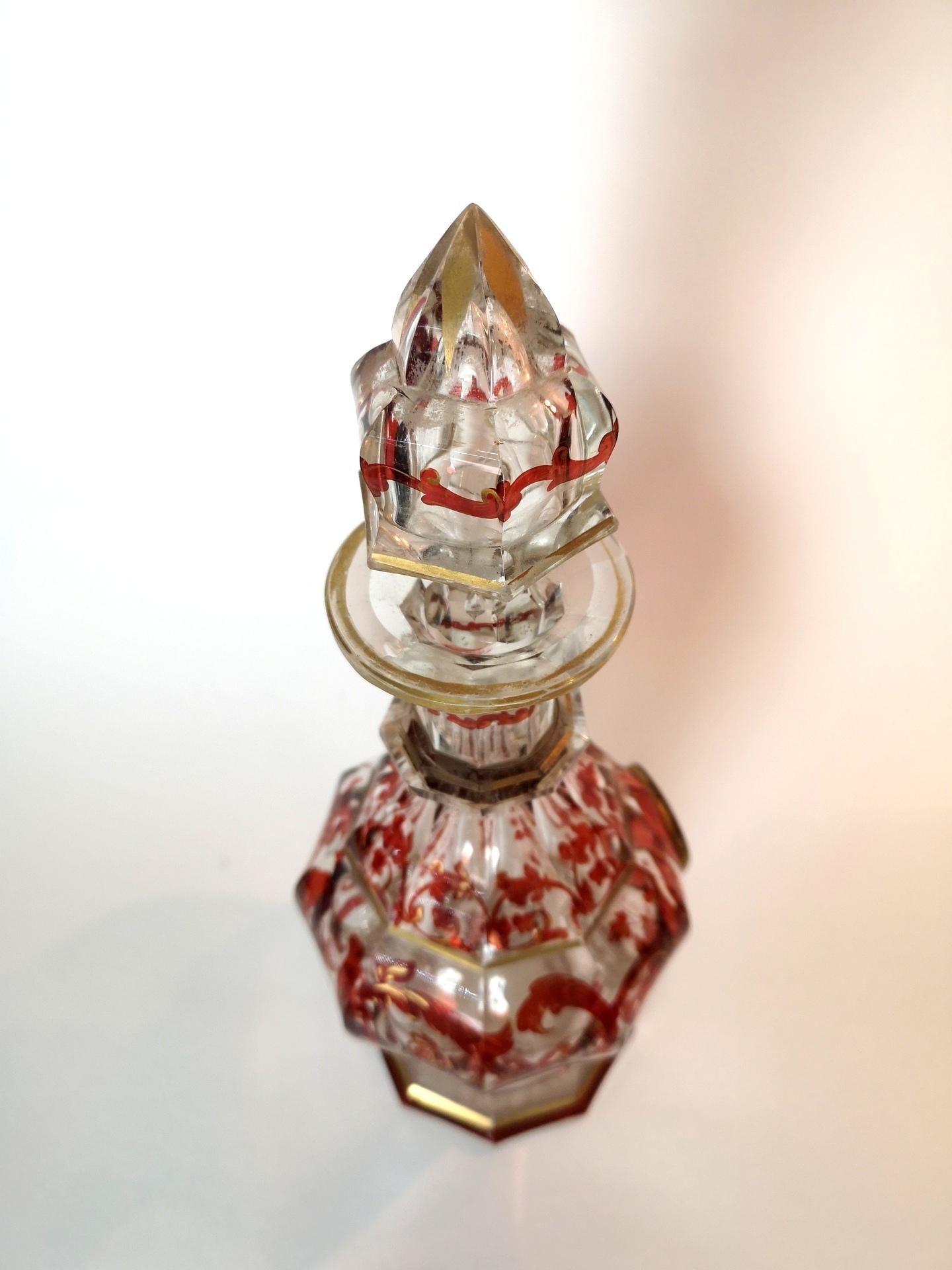 This beautiful Biedermeier decanter features a red hand-painted grapevine pattern, which is complemented elegantly with the modest gold plated decorations. A classy addition to your liquor cabinet for wine or any spirits of choice. The styling of