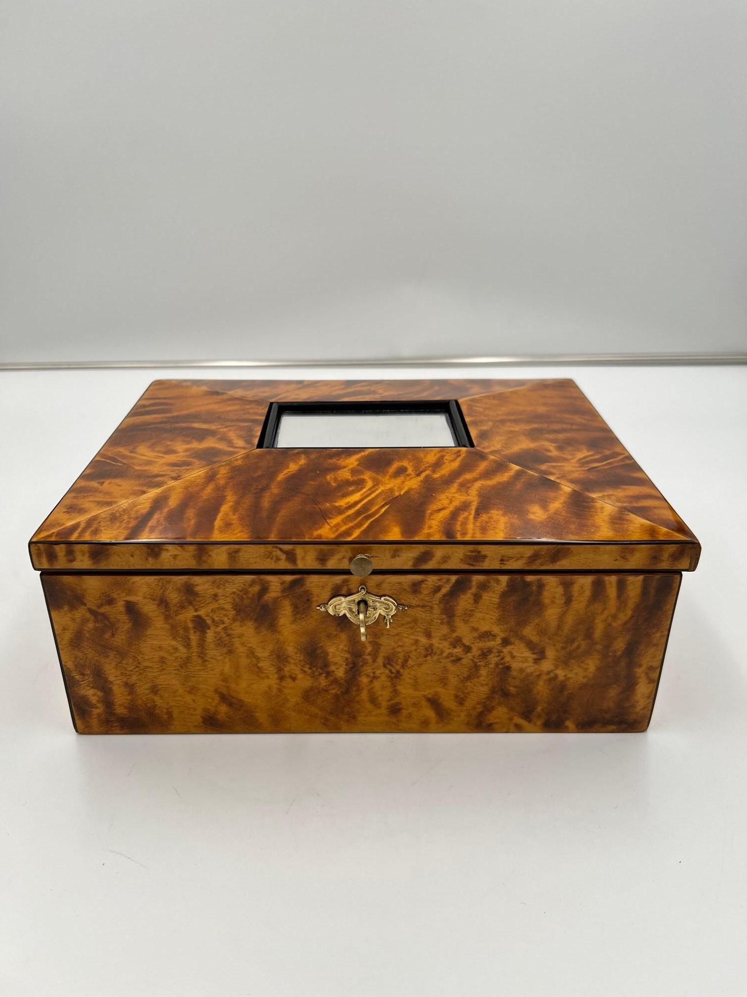 Beautiful Biedermeier Jewelry Box in Birch Wood from Austria circa 1820
Flamed birch veneer. Ebony inlay. Inside in bright Maple wood.
Mirror inserted into the top of the lid. Brass button and fitting.
Restored and hand polished with