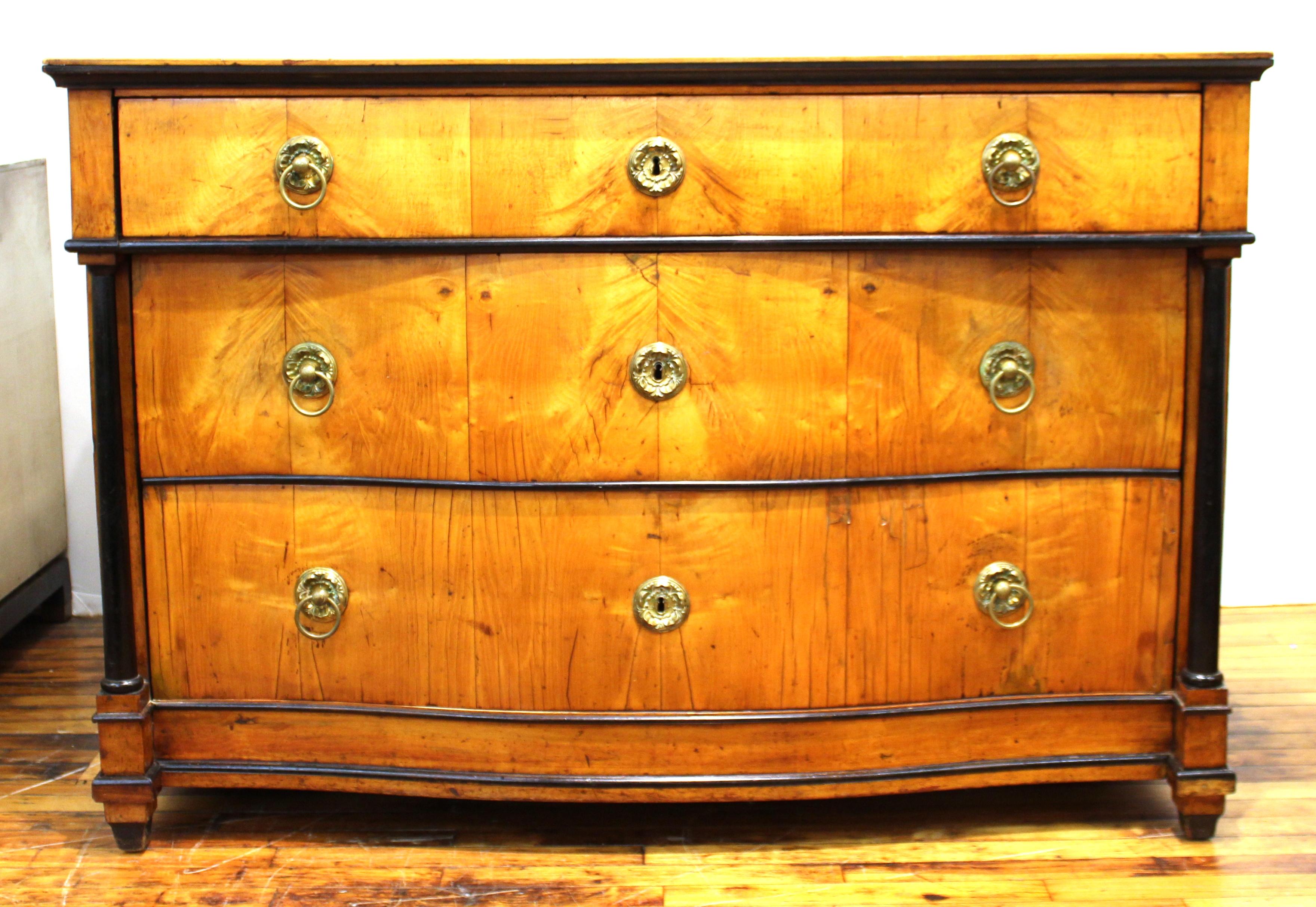 Large Biedermeier commode or chest of drawers with 3 individual drawers with metal embellishments and ebonized details. The piece was possibly made in Austria in the early 20th Century and is in good antique condition.