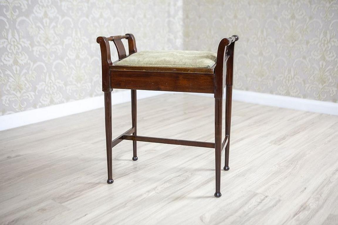 Biedermeier Inlaid Mahogany Stool from the Late 19th Century

We present you this neat French stool from the 2nd half of the 19th century.
The upholstered seat is placed on four rounded legs, which narrow towards the bottom. The legs are supported