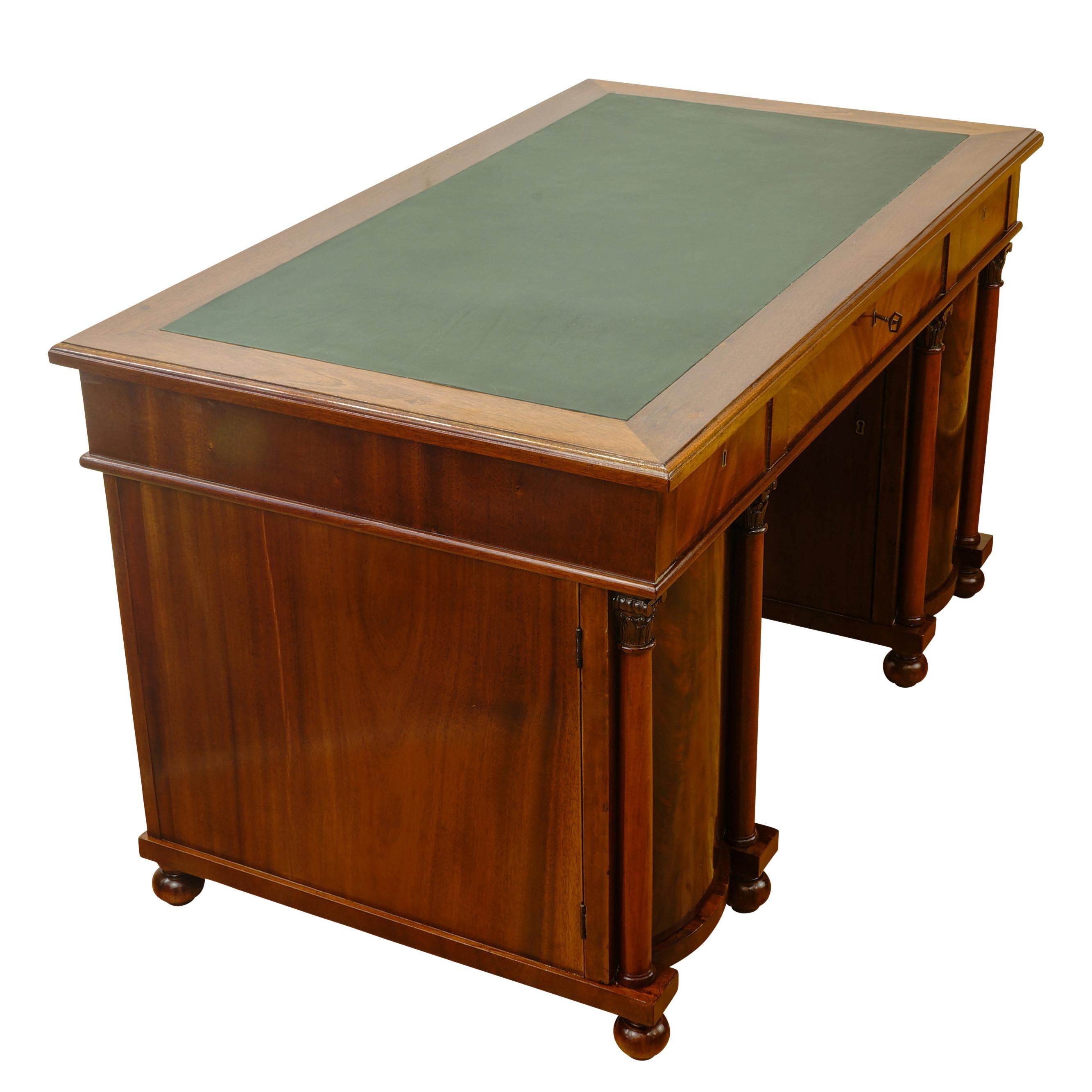 Recently fully refinished with writing surface resurfaced in green leather. This desk features two highly adorned barrel fronted storage cabinet topped by a three drawer writing surface. Original keys and hardware are fully functional.