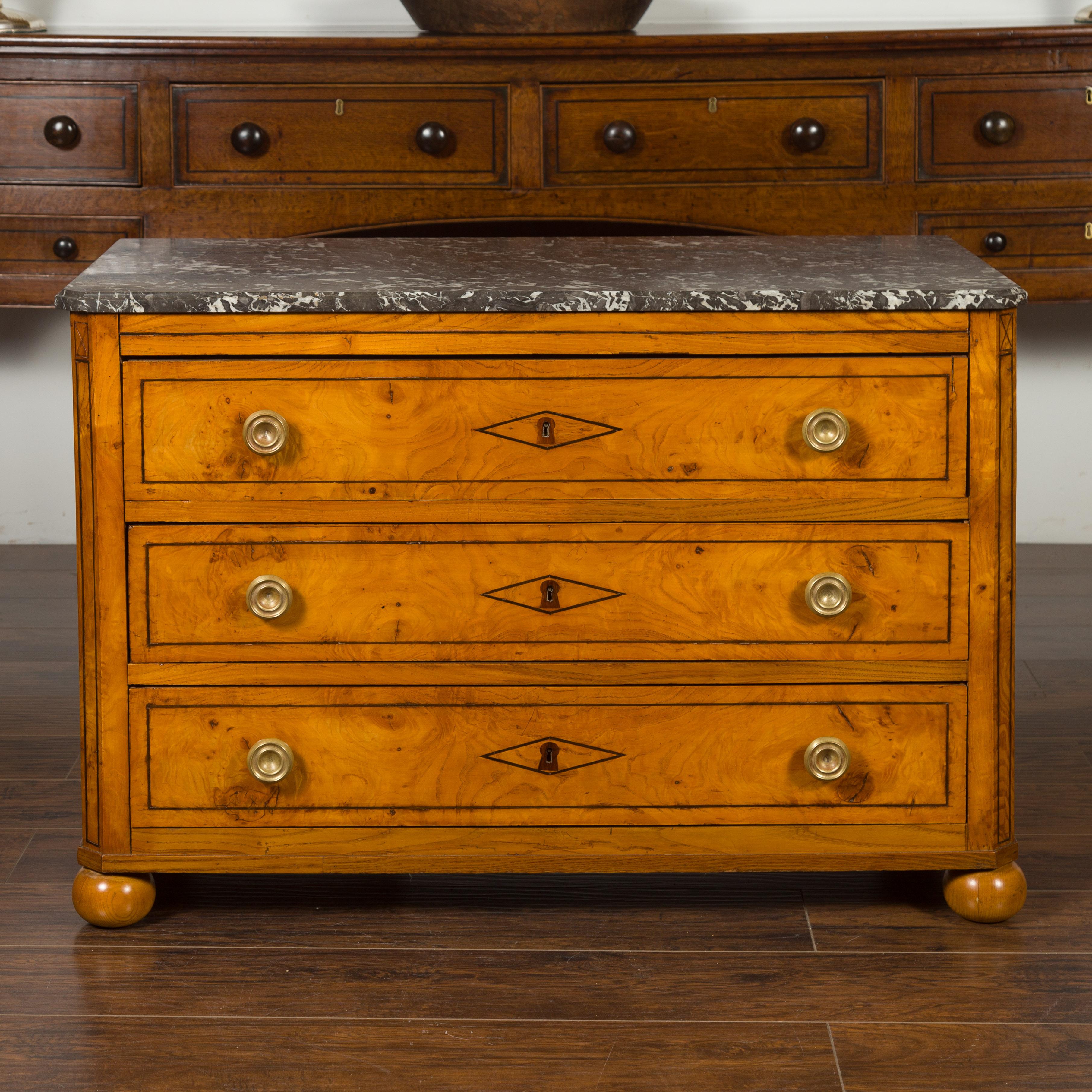 A Biedermeier period walnut three-drawer commode from the mid-19th century, with grey marble top and banding. Created in Austria during the first half of the 19th century, this walnut commode features a rectangular variegated grey marble top with