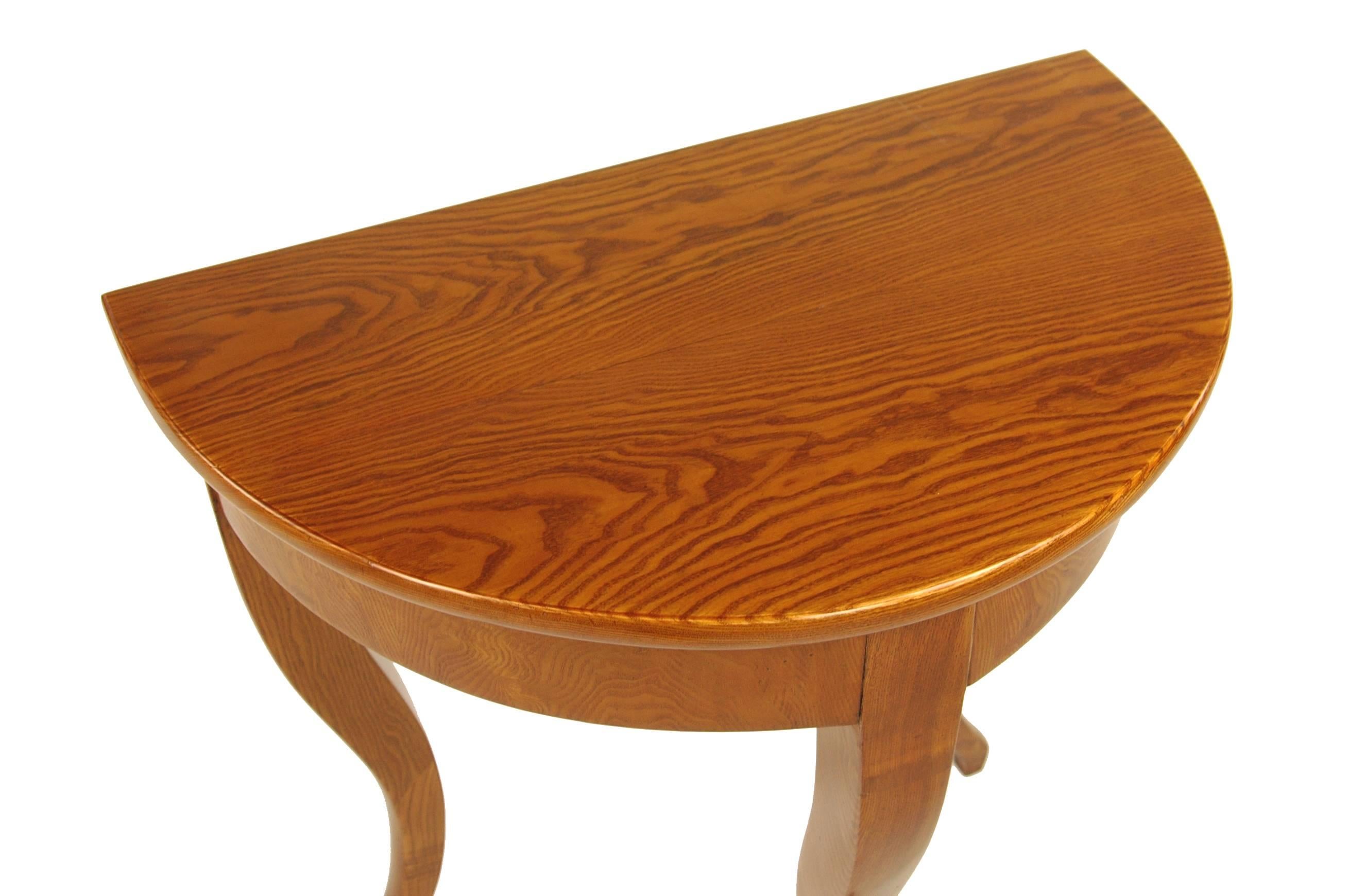 Demilune console tables are usually made on three sides only and have three legs, as they stand on the wall with their non-veneered part.
The legs of our solid ash console table are curved, which refers to the late Biedermeier era.
The console