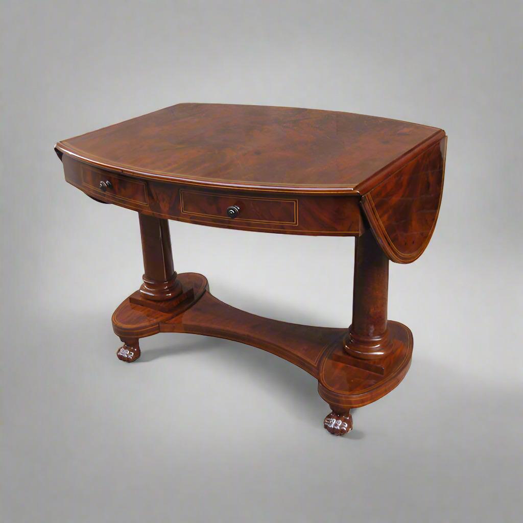 A fine Biederemeier period oval library table desk with folding extensions on each side from Germany circa 1820.  Beautiful hardwood timber with fruitwood inlays and fine carved paw feet details along with two drawers.