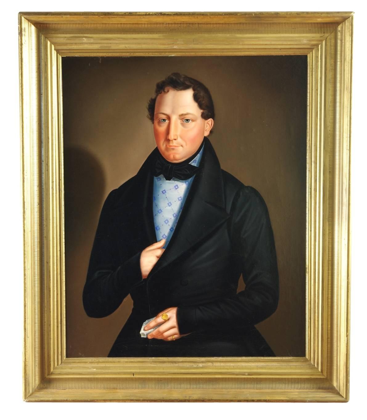 Biedermeier portrait of a gentleman, the young man with liquid blue eyes dressed in formal attire, wearing a gold monogrammed ring and holding a silver snuff box. Oil on canvas, laid down on foam-core, in a 19th century giltwood frame.
Measures: