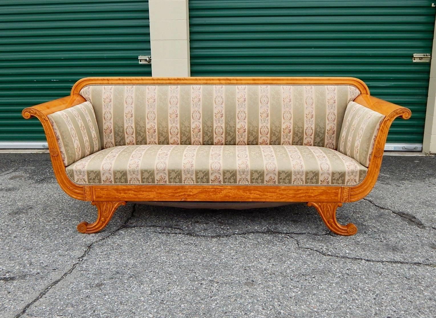 Swedish Biedermeier revival sofa rendered in highly figured golden flame birch wood. With scroll arms and legs. Panelled sides also rendered in birch. Back is unfinished. In excellent original condition with some ware, Sweden, 1920s.