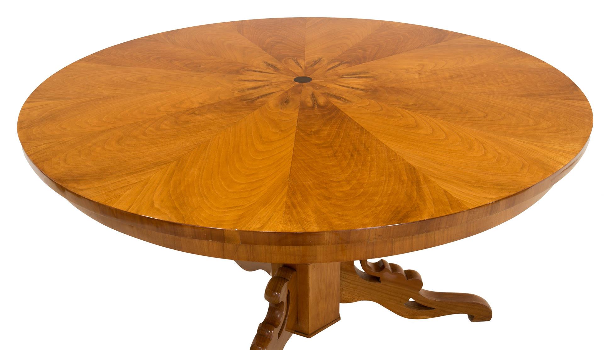 This Biedermeier round table was made in Germany in 19th century. It is supported on a beautifully sculpted leg made of cherrywood, the tabletop is also veneered with cherrywood. The piece has been refinished with varnish which besides great visual