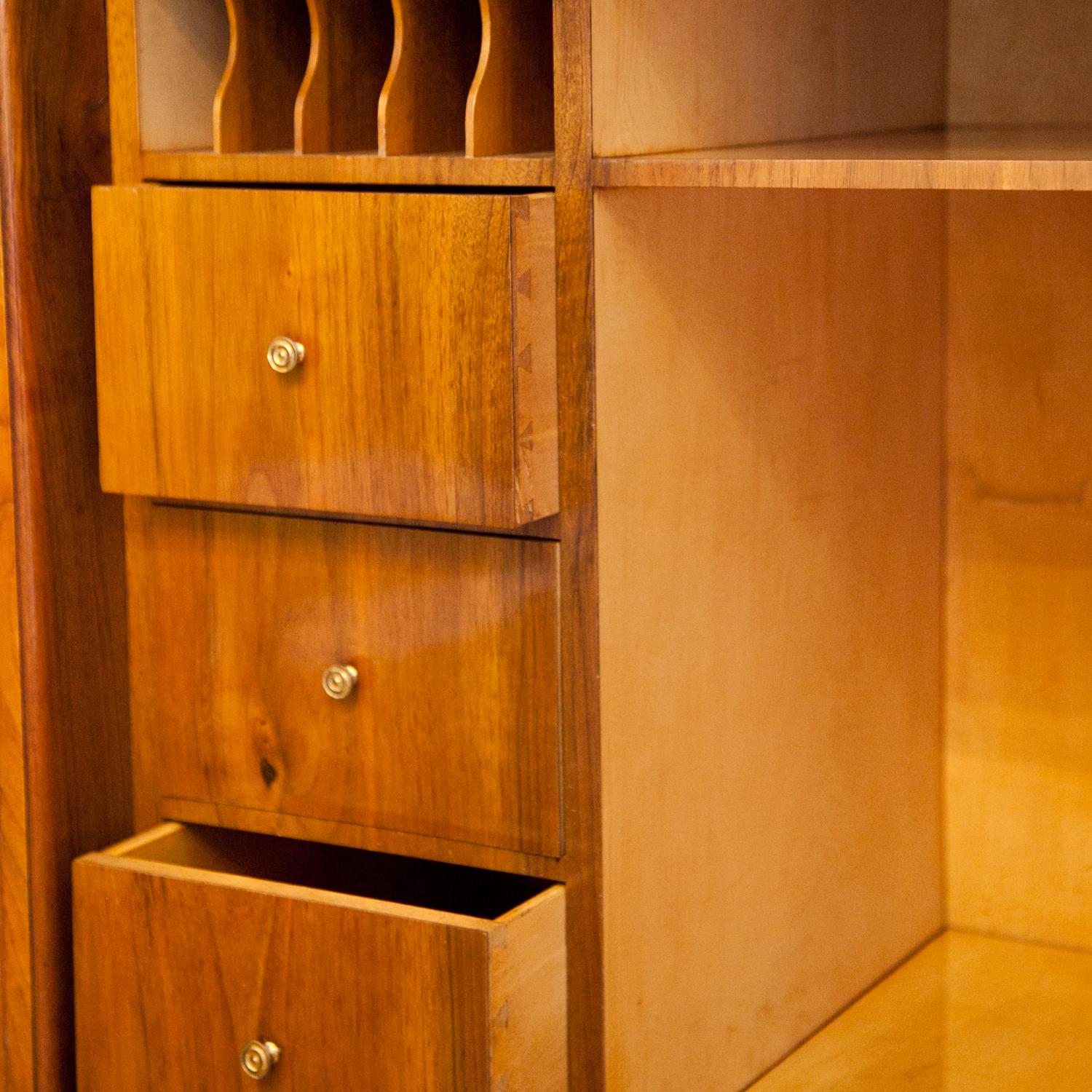 Biedermeier Secretaire with a two-doored base, one top drawer and lateral three-quarter columns, standing on cylindrical feet. The interior is partly veneered in maple and has six drawers and pigeonholes as well as a two hidden compartments.