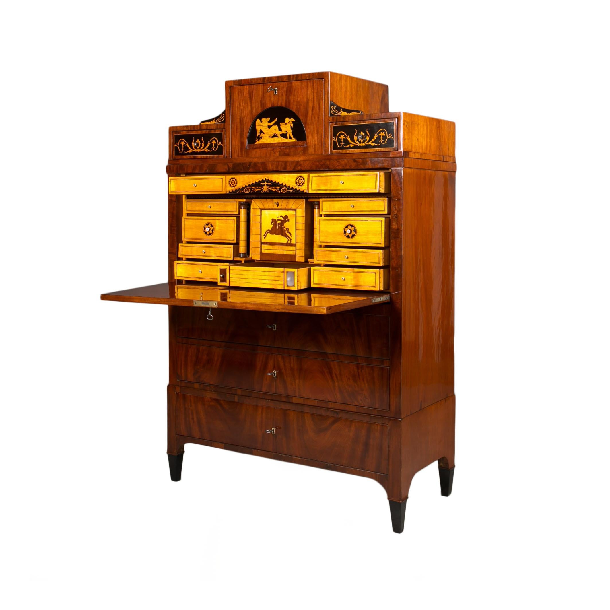 This beautiful Secretary comes from Austria and was made in 19th century. The piece is made of oak wood, veneered with mahogany veneer. When opening the main section the doors transform into a writing desktop revealing a section with multiple small