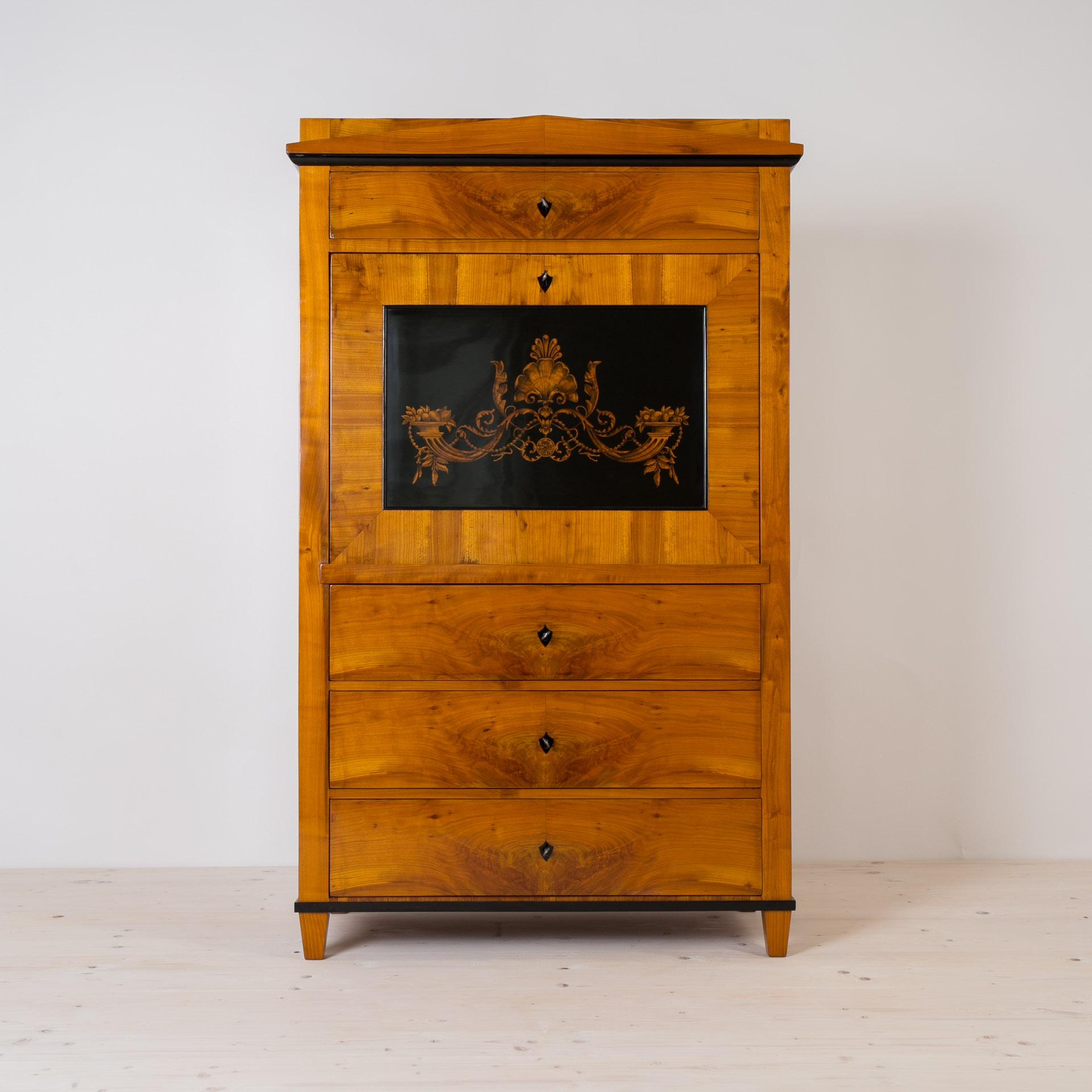 This beautiful Secretary comes from Germany and was made in 19th century. The piece is made of pine wood, veneered with cherry wood veneer. When opening the main section the doors transform into a writing desktop revealing a section with multiple