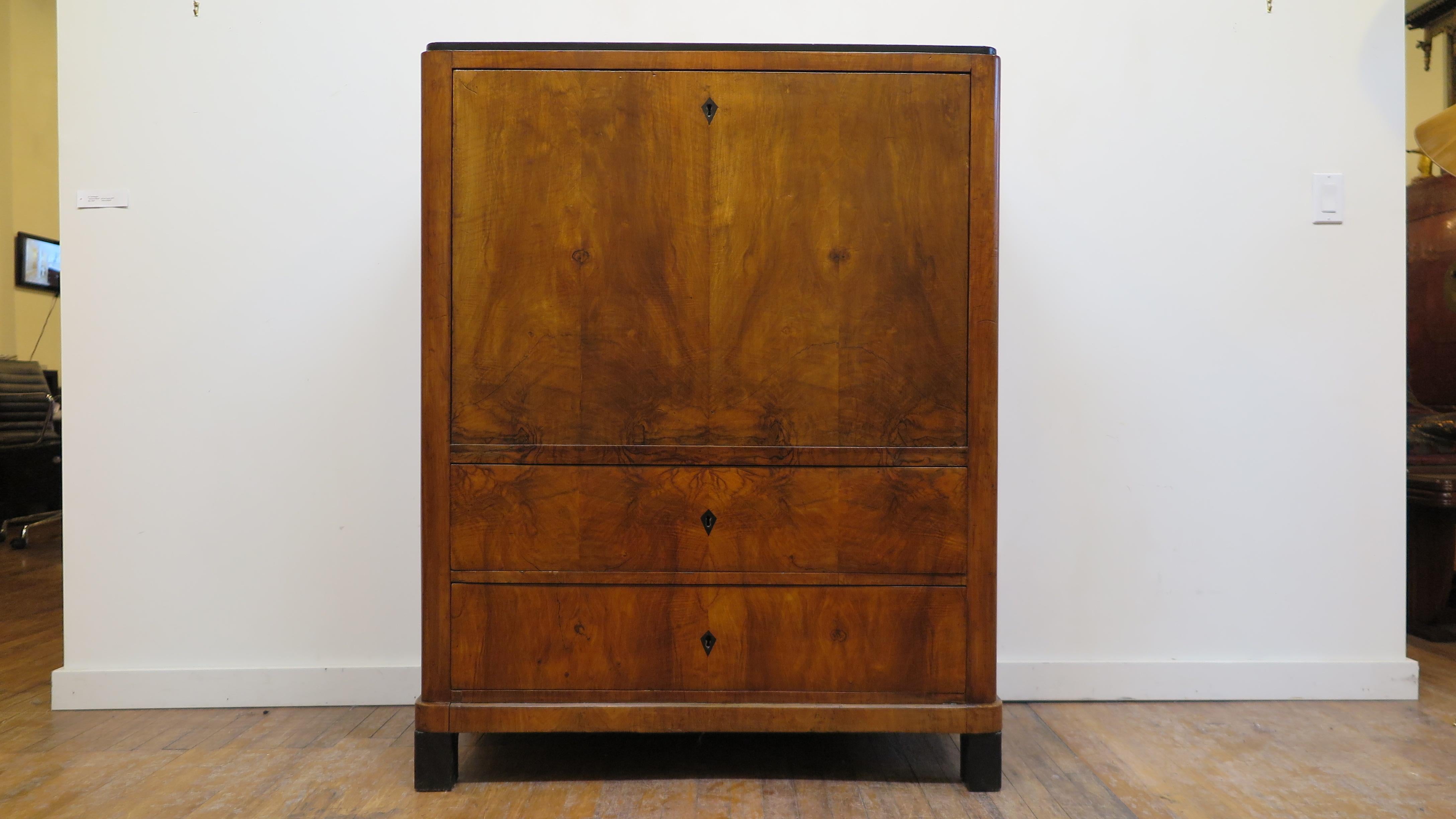 Biedermeier secretary 19th century walnut burl, 1820s. Good size Biedermeier secretary having a folding desk top writing table with two large lower drawers outside. Inside having 8 drawer configuration around open arched center compartment. In good