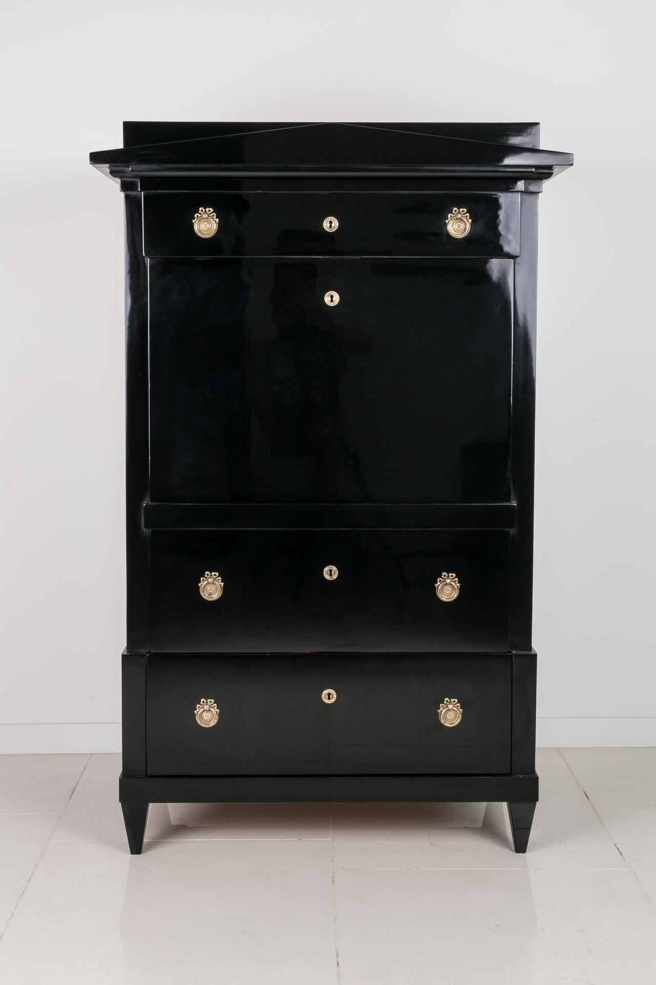 This Biedermeier secretary comes from Germany and was constructed in 19th century. It is made of coniferous wood, veneered with birch. It has undergone a professional renovation process. Surface finished with black shellac polish applied by hand