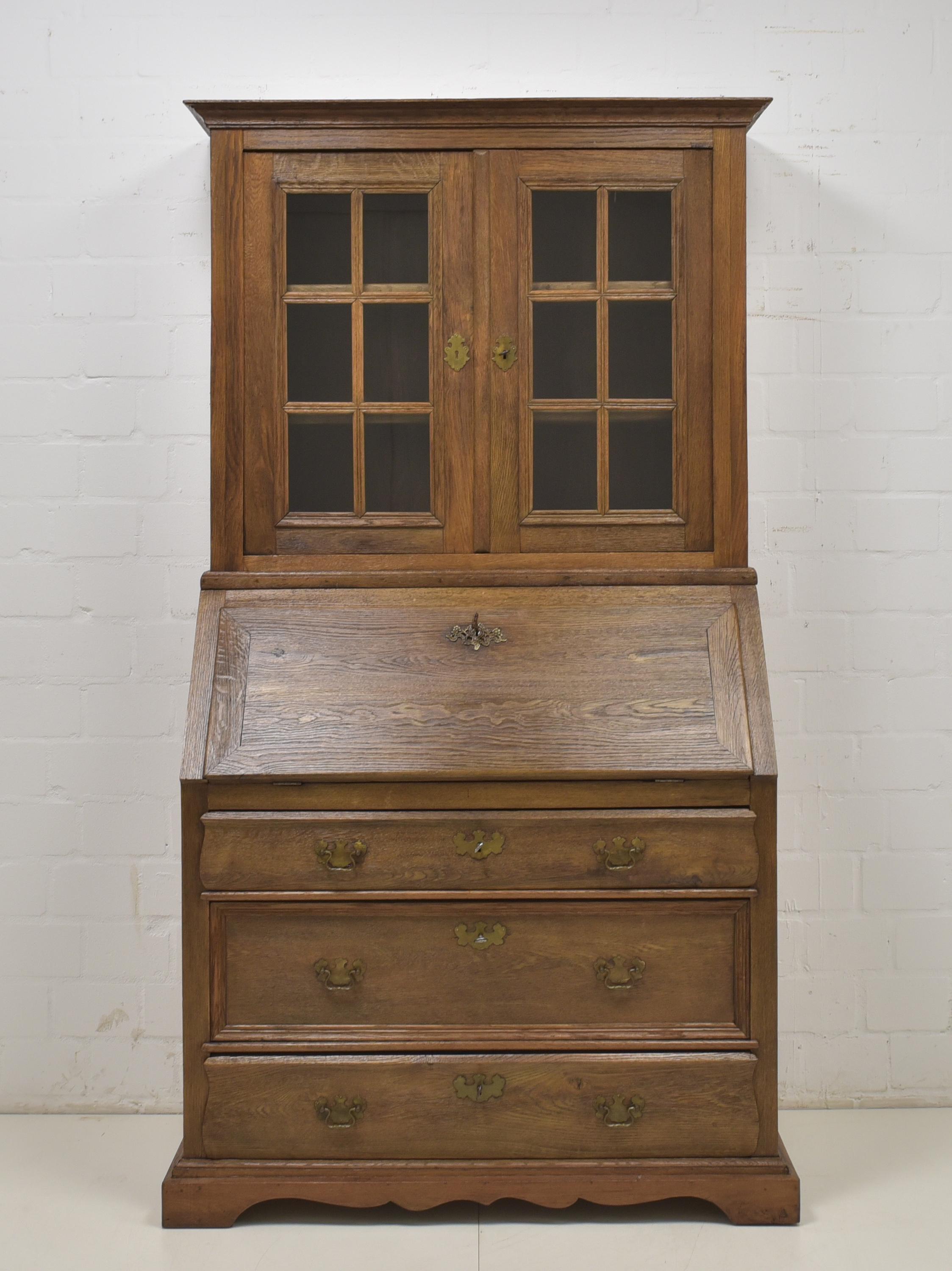 Secretary with showcase restored Biedermeier around 1830 solid oak

Features:
Model with writing flap, three drawers and two-door display case
Interior with seven drawers and one open compartment
High quality
Heavy quality
All drawers