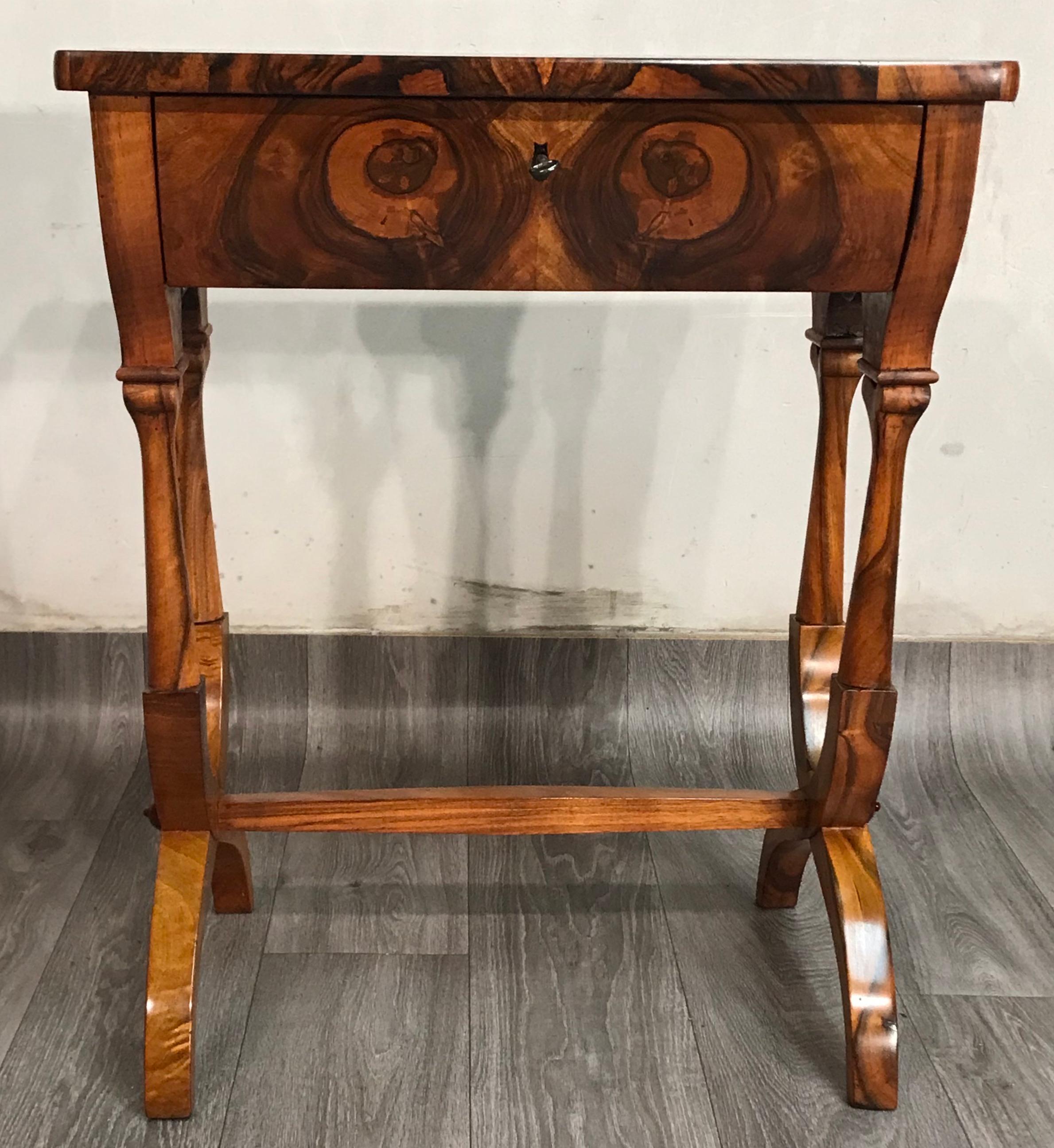 Unique and original Biedermeier sewing or side table, which dates back to circa 1820 and originates in Austria. The table has one-drawer, inside it are different compartments for sewing utensils. The base of the table is beautifully designed.