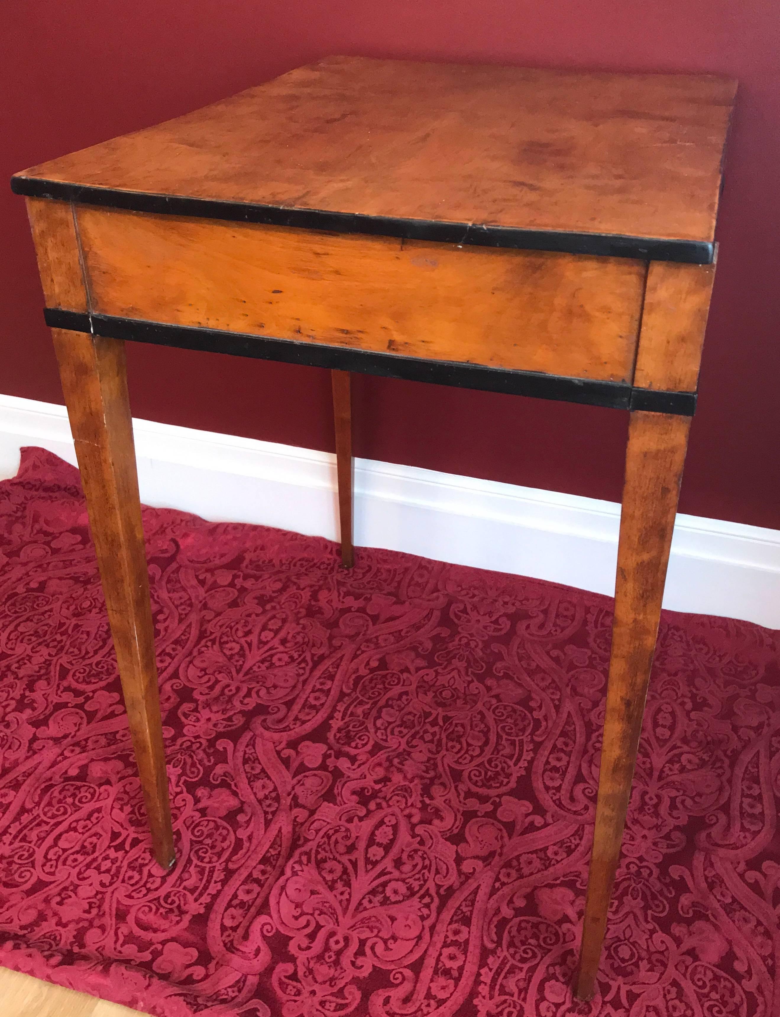 Biedermeier Sewing table, Germany, 1830, birchwood veneer with ebonized details. One drawer with different compartments and pin cushion. In restored condition without loosing its vintage charm. The key is missing.