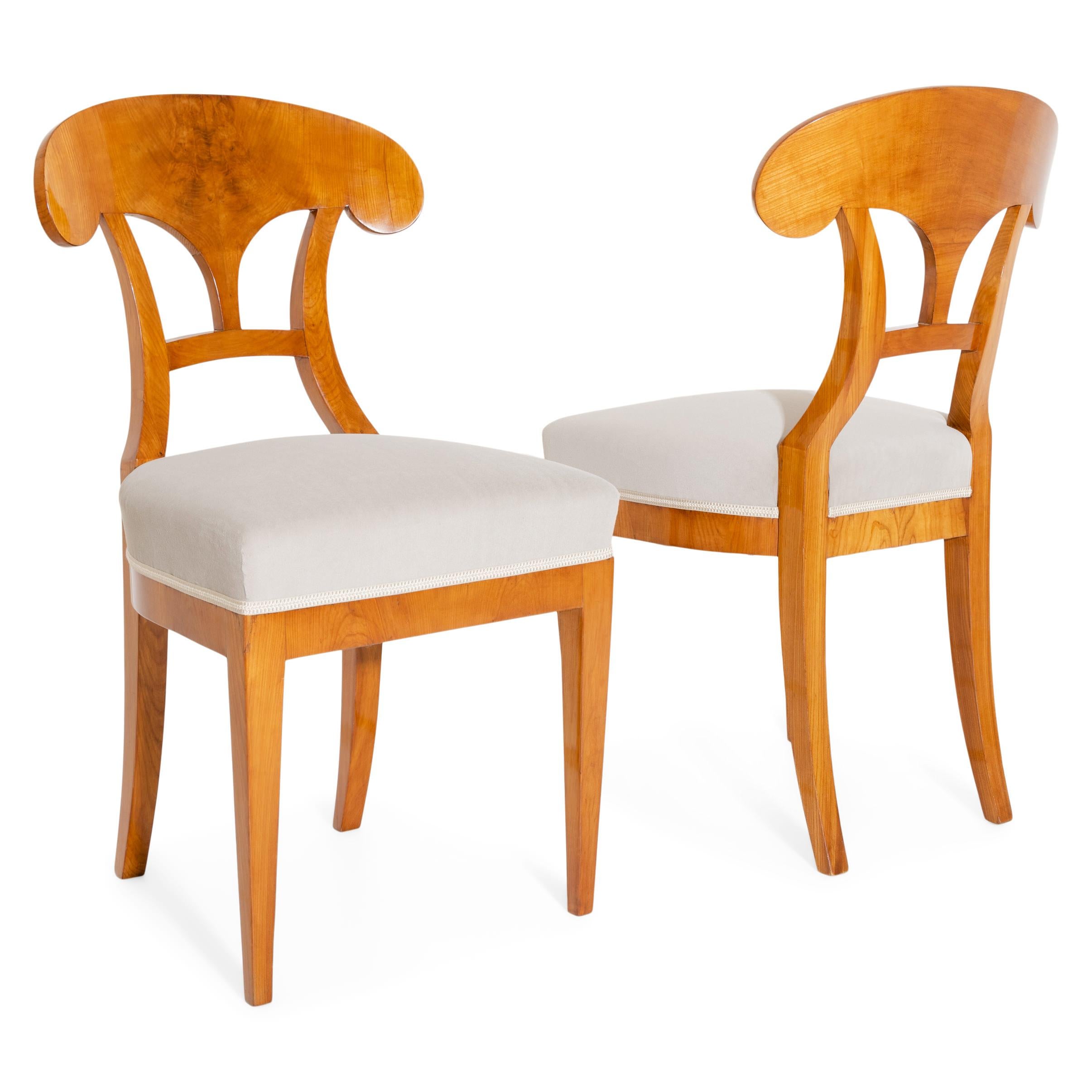 Pair of Biedermeier shovel chairs in cherry. The seats have been reupholstered with a grey velvet fabric. The chairs have been professionally refurbished and hand polished.