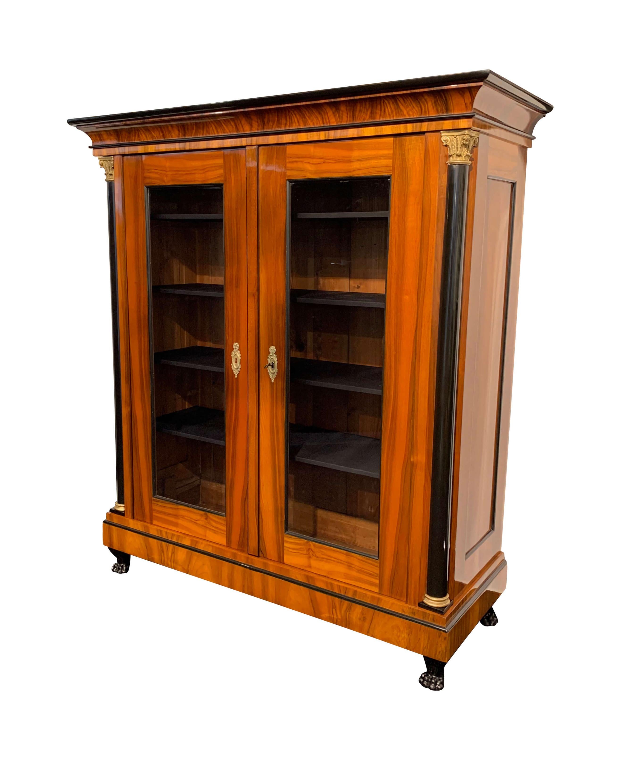 Large, impressive original Biedermeier showcase armoire / display cabinet from South Germany, about 1820/25.

Walnut veneer and solid, hand-polished with shellac (French polish). Nicely worked, classicist concave cornice. Set, ebonized