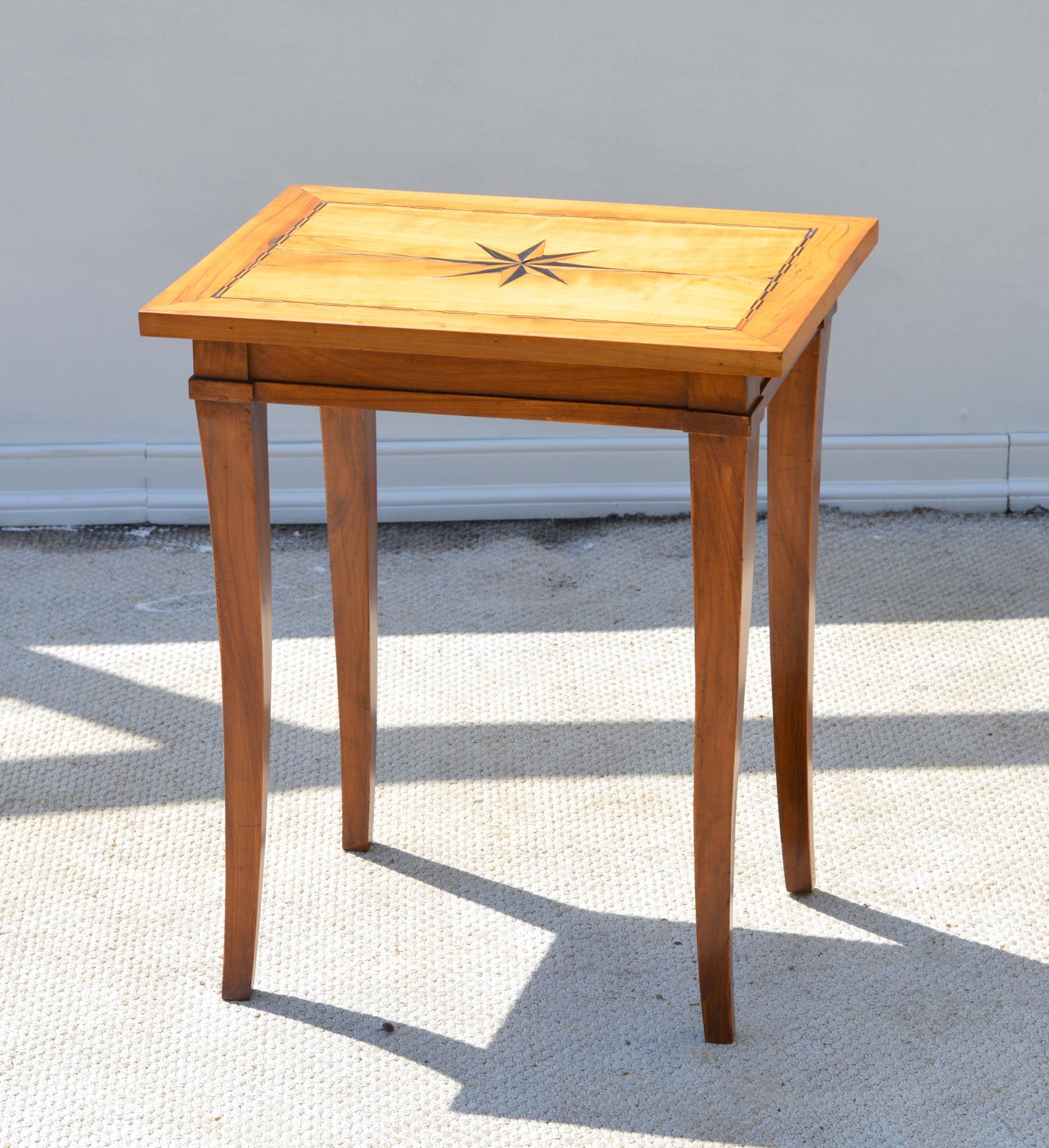A fruitwood side table in the second Biedermeier taste, circa 1935. The table is set off by a well performed North Star inlay of ebony and birch wood. The clean lines and useful nature of this simple side table make it a Classic.